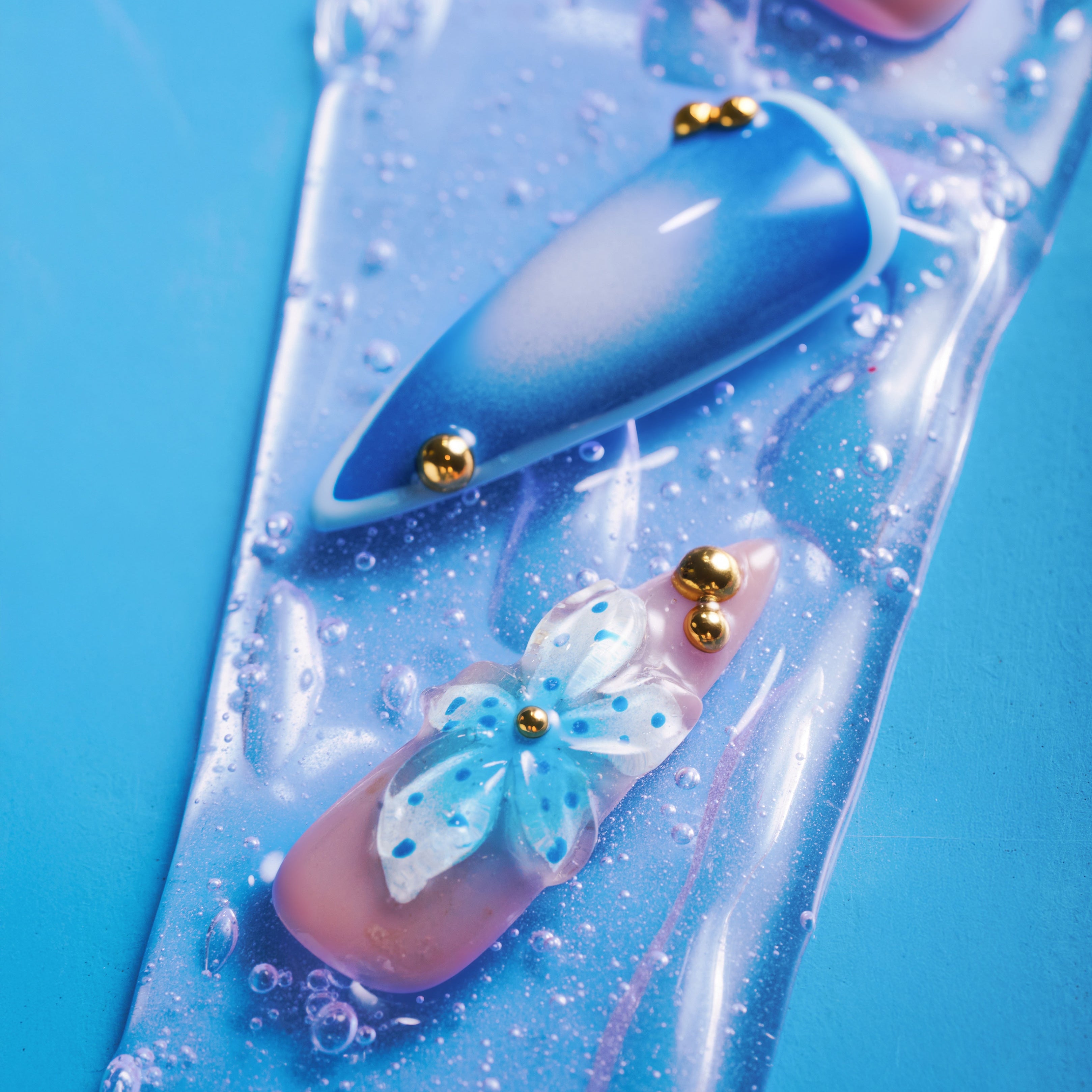 Azure Flutter press on nails with blue gradient design, 3D floral accents and gold beads