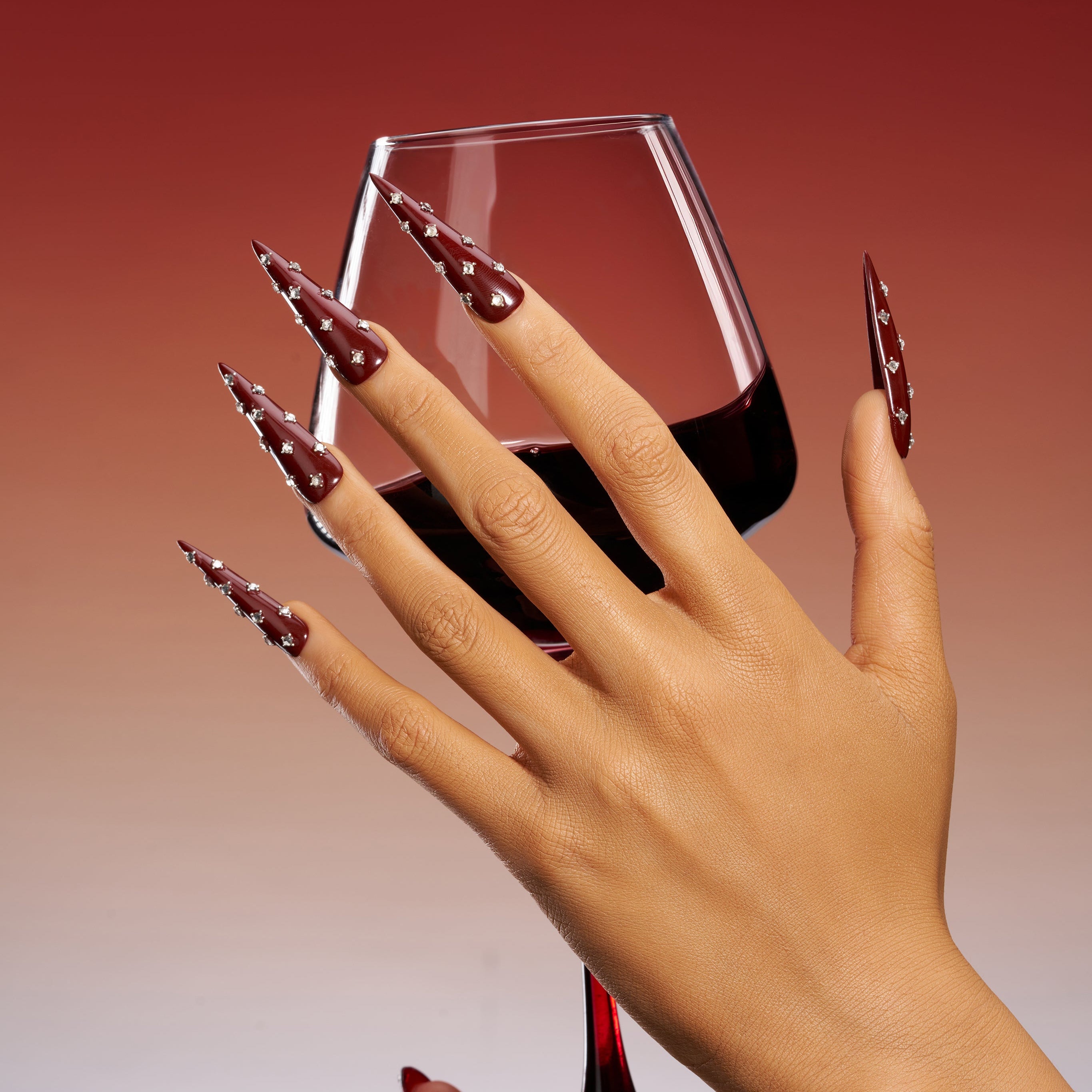 Deep burgundy long press on nails with crystal accents. Elegant reusable statement nail set.