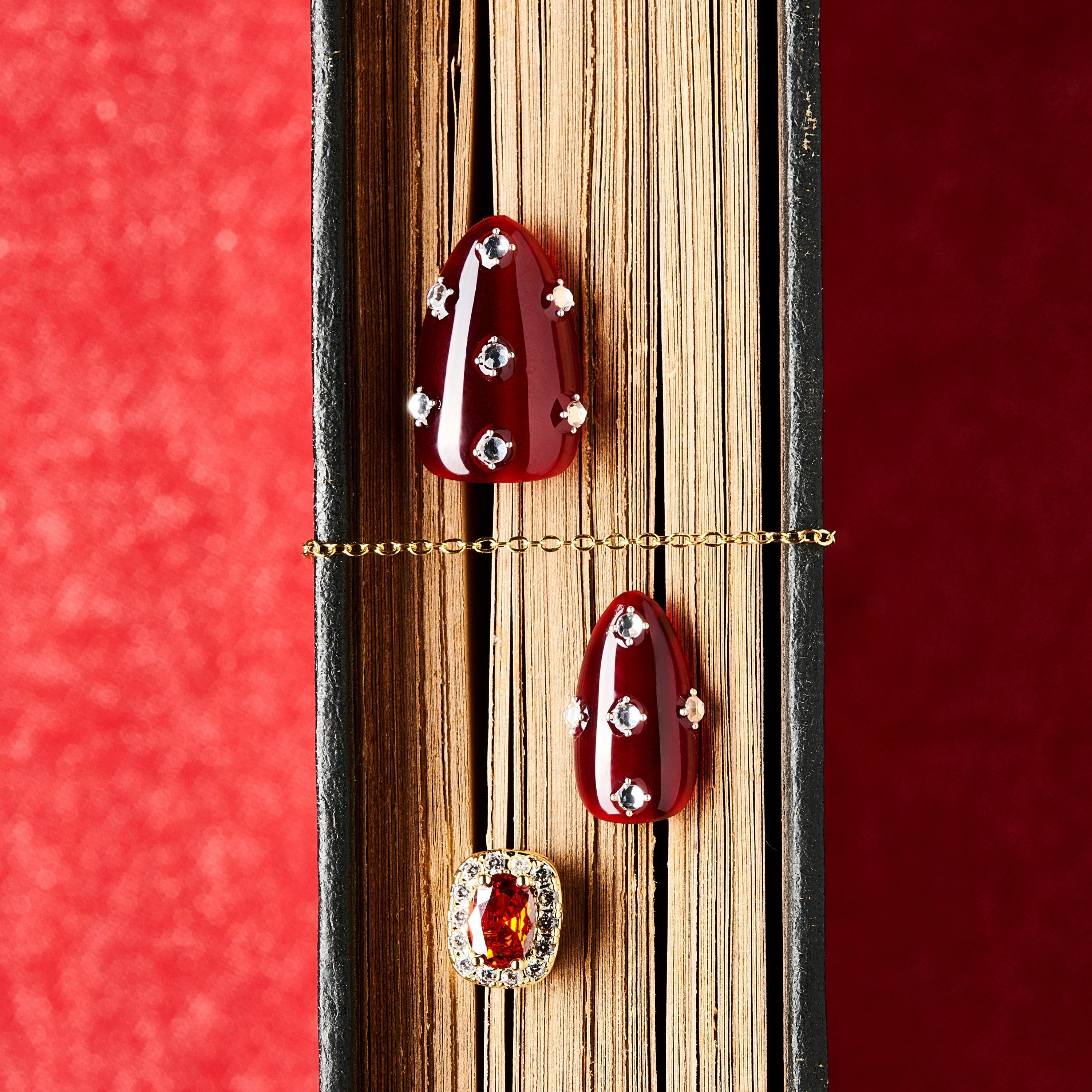 Short burgundy press on nails with crystal detailing. Reusable elegant nail art set.