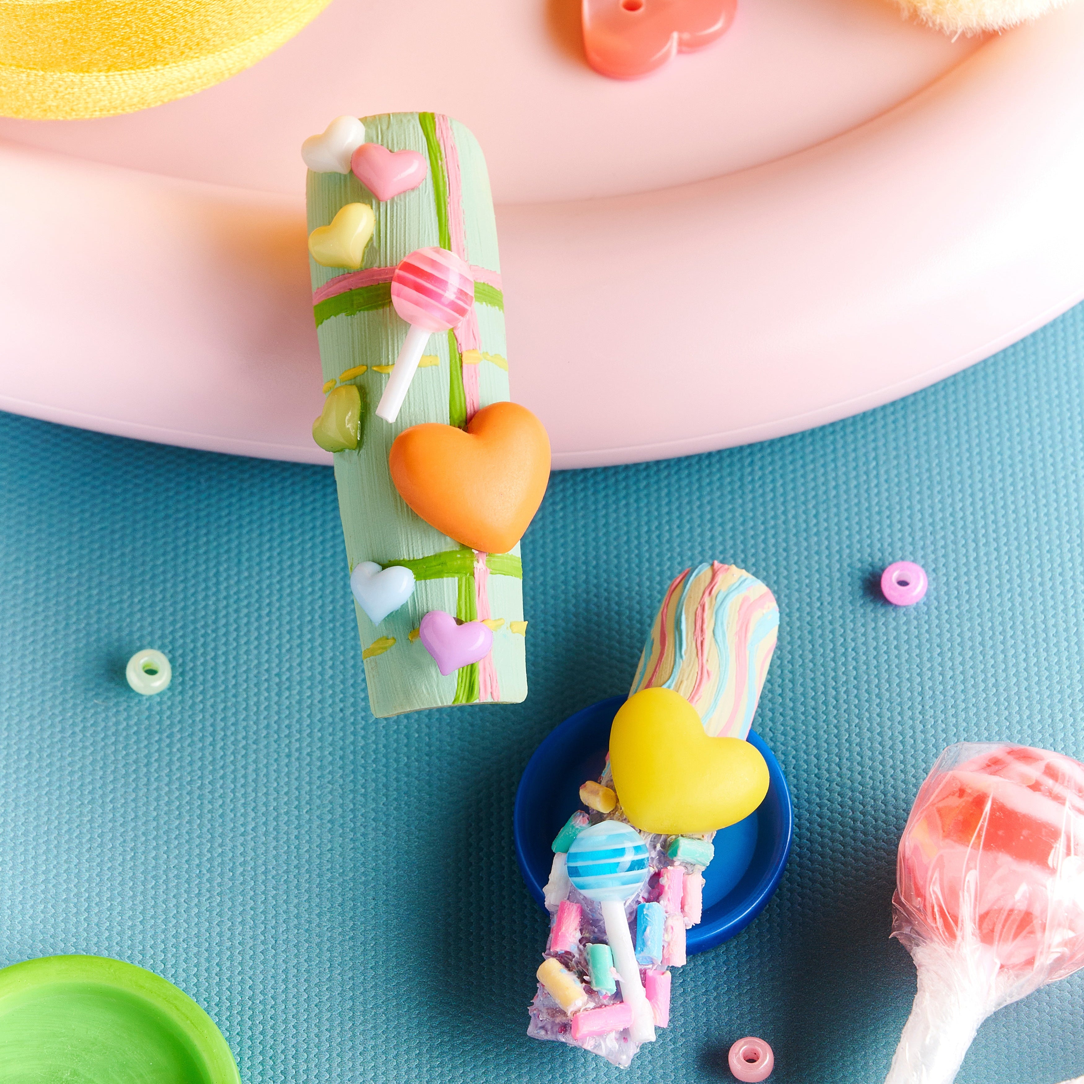 Playful 3D candy heart press on nails in pastel tones. Reusable Y2K-inspired nail art set.