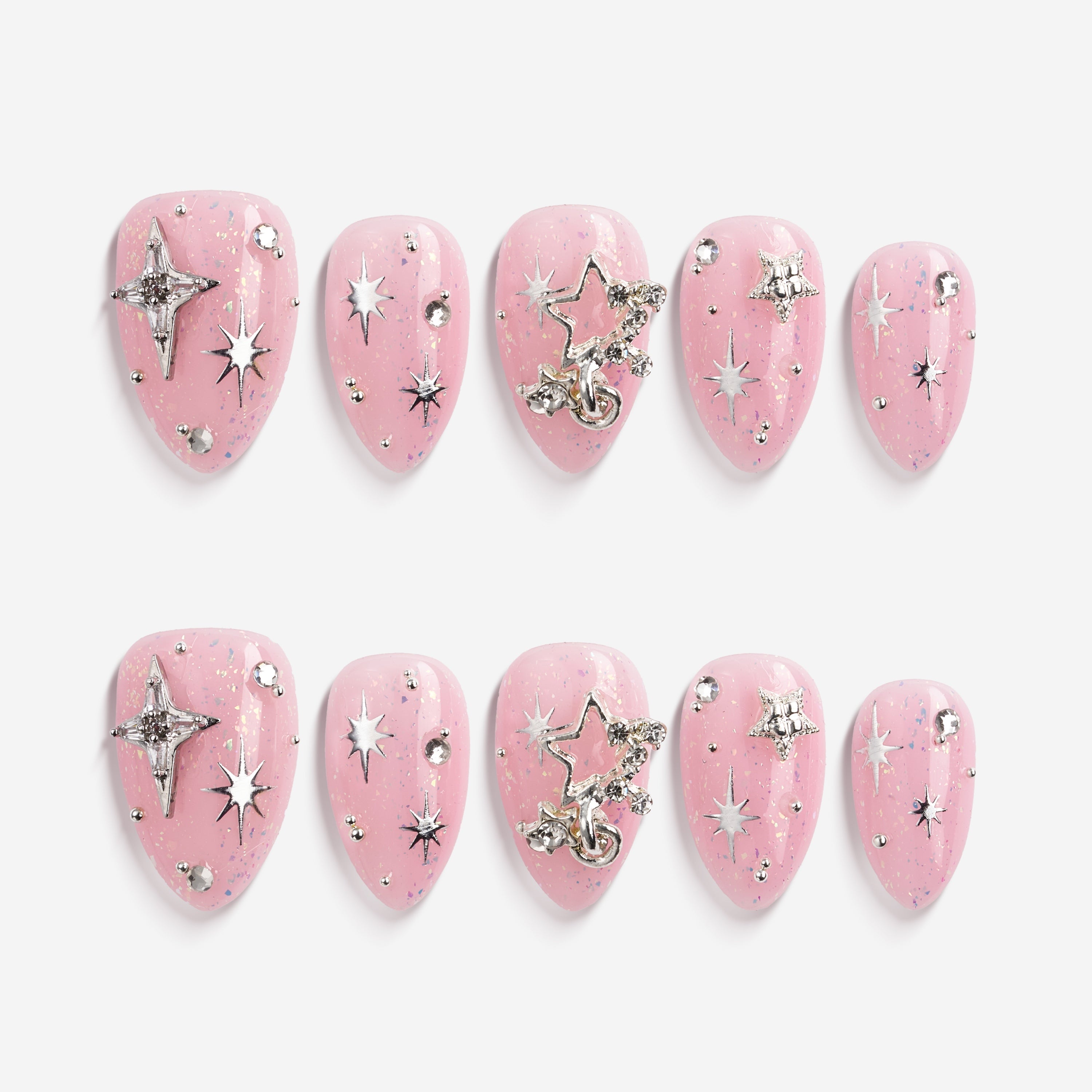 Dreamy pink glitter press on nails with star charms and crystal details. Soft glam and reusable.