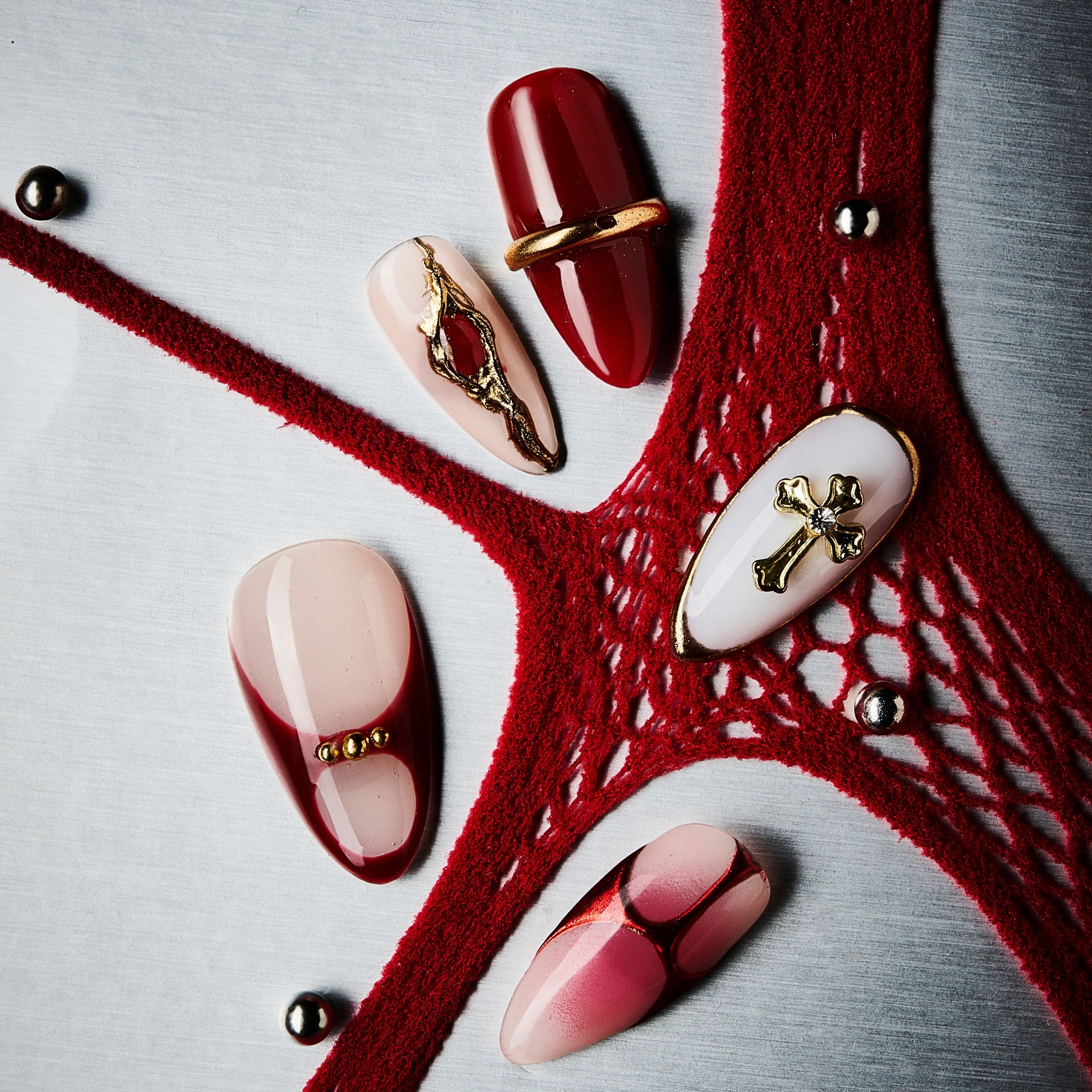 Bold red coffin press on nails with gold cross accents and gradient finish. Dramatic, elegant and reusable.