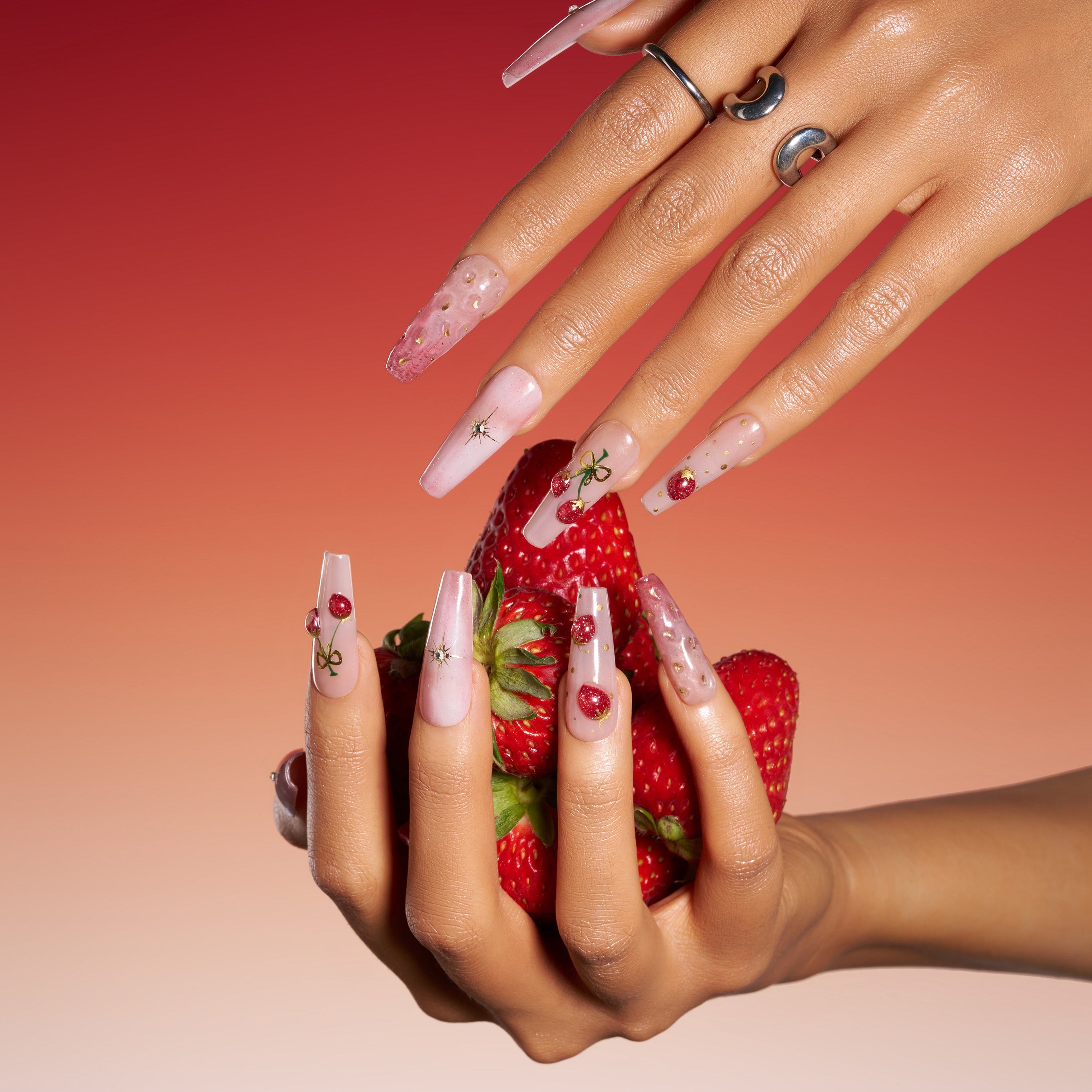 Cherry Glow nude press on nails with cherry accents and glossy finish