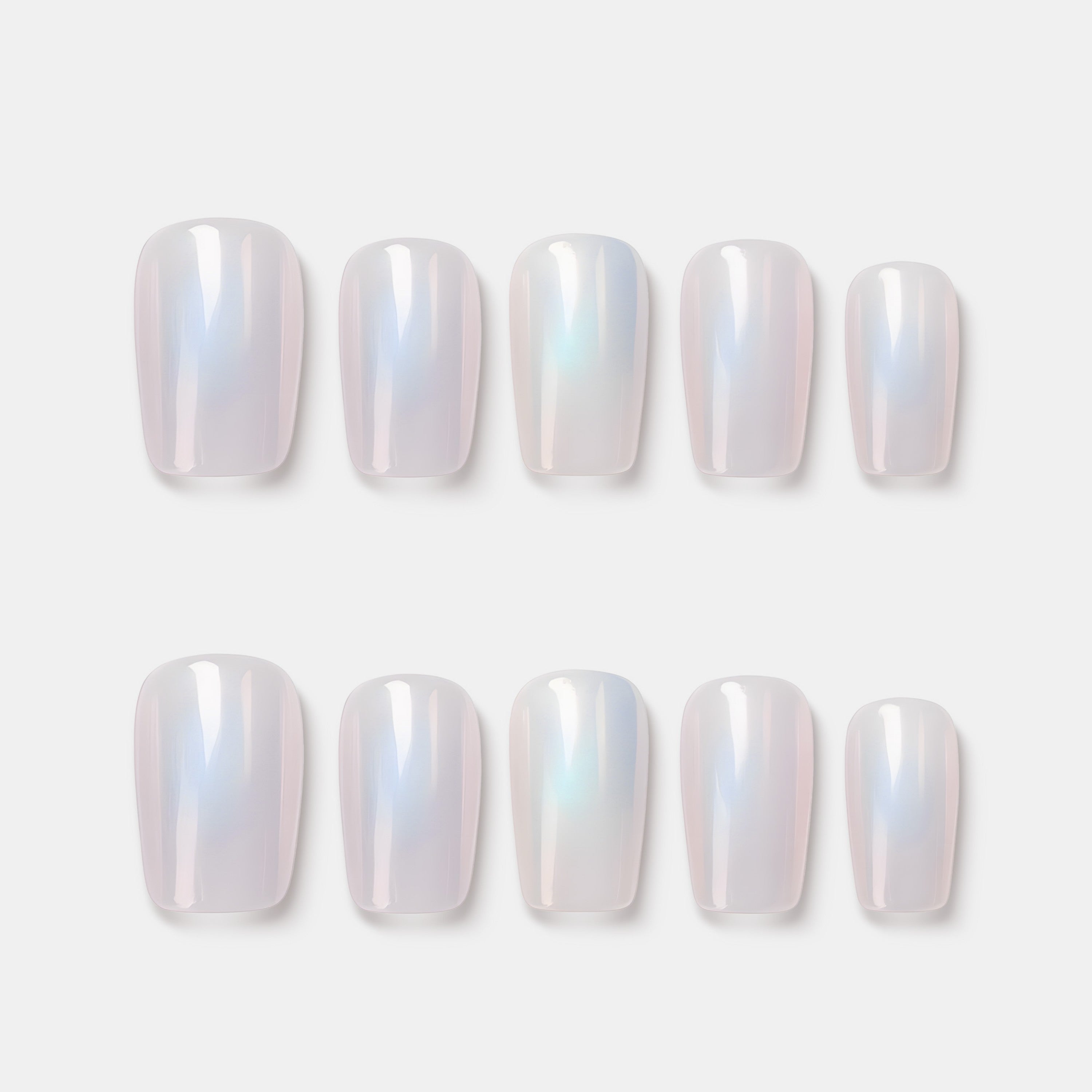 Moonbow Icing press on nails featuring milky white iridescent glow. Trendy luminous false nails.