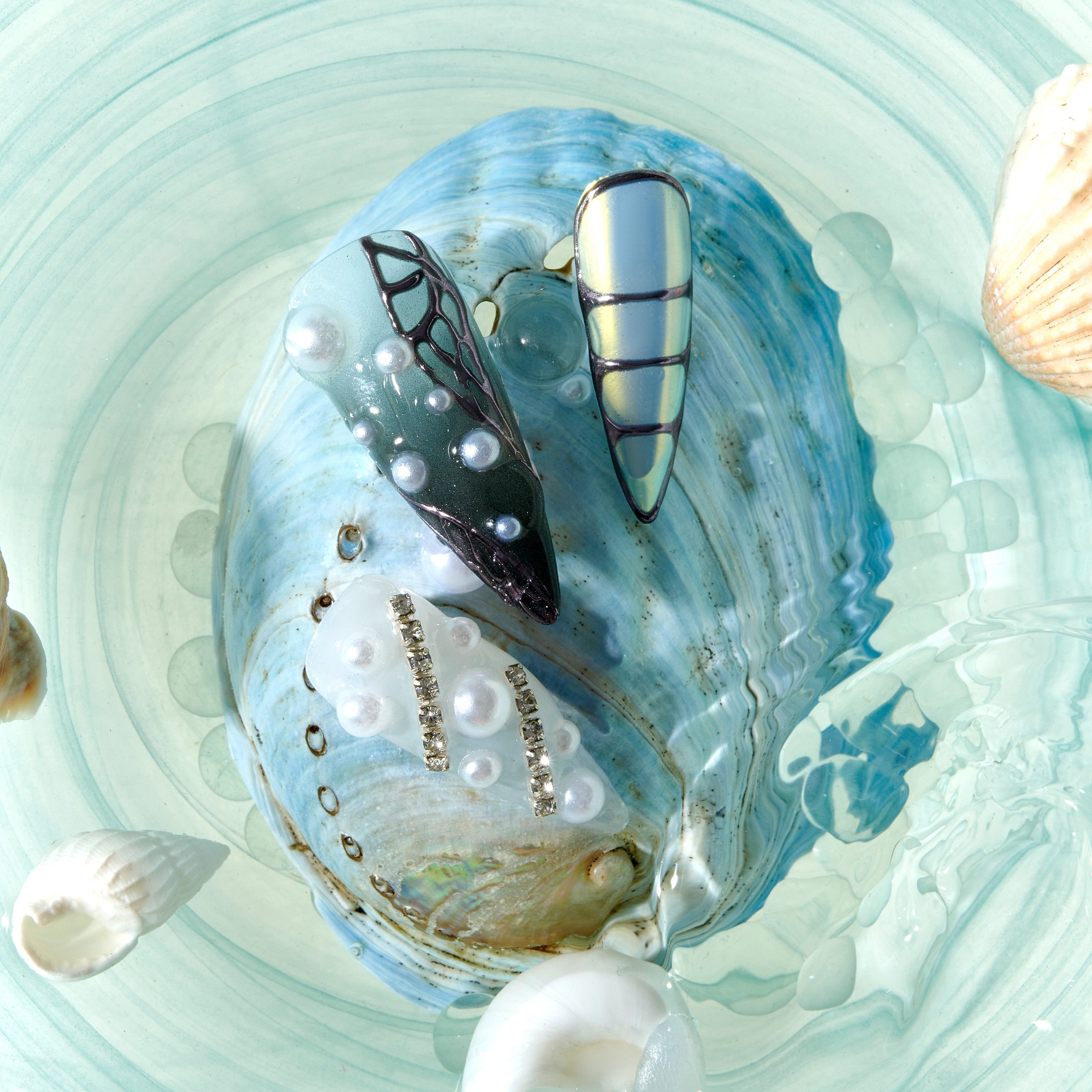 dresup Silver Coral press on nails featuring chrome texture and pearl details. Luxury ocean-inspired false nails.