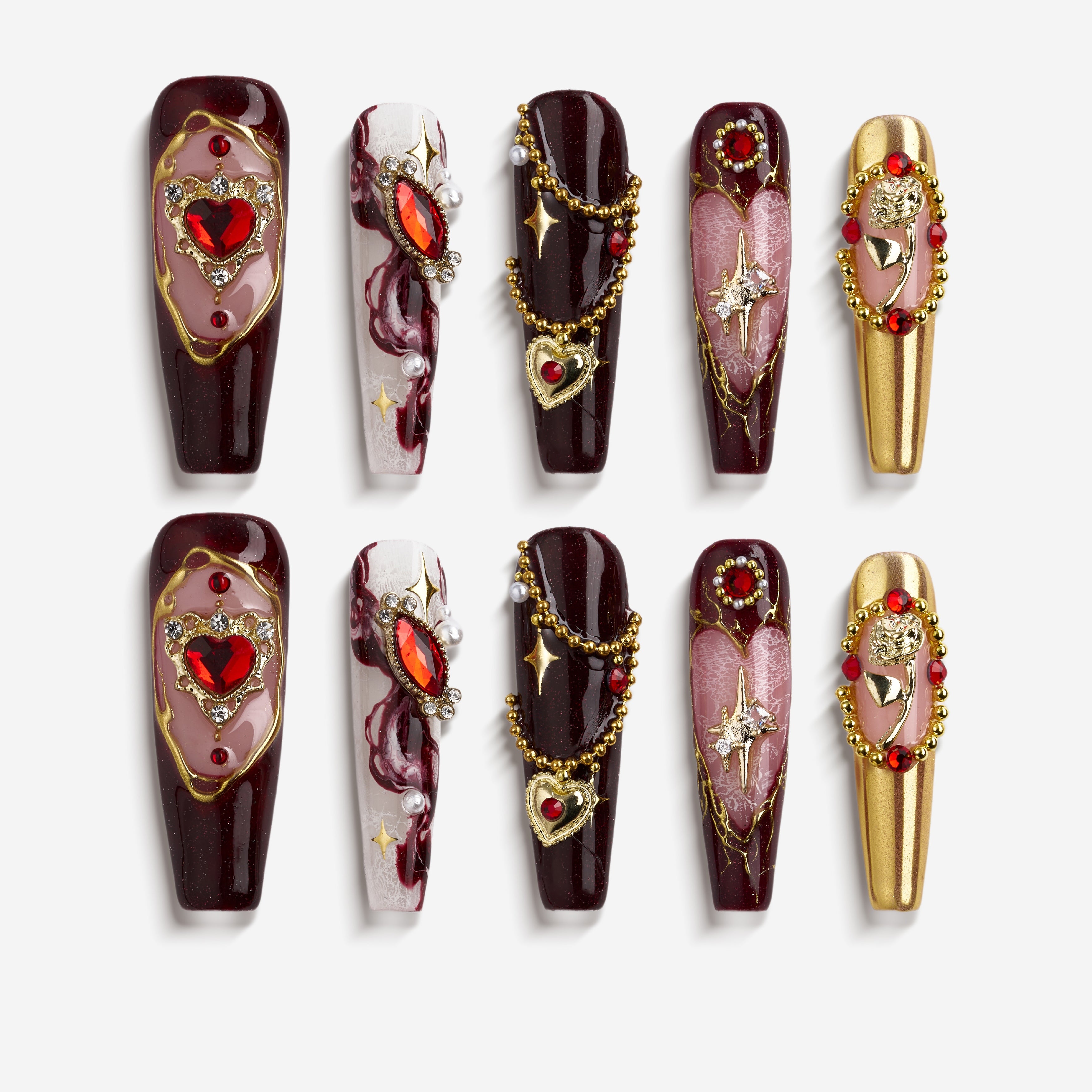 Burgundy press on nails with gold detailing and heart gemstone accents. Romantic, bold and reusable.