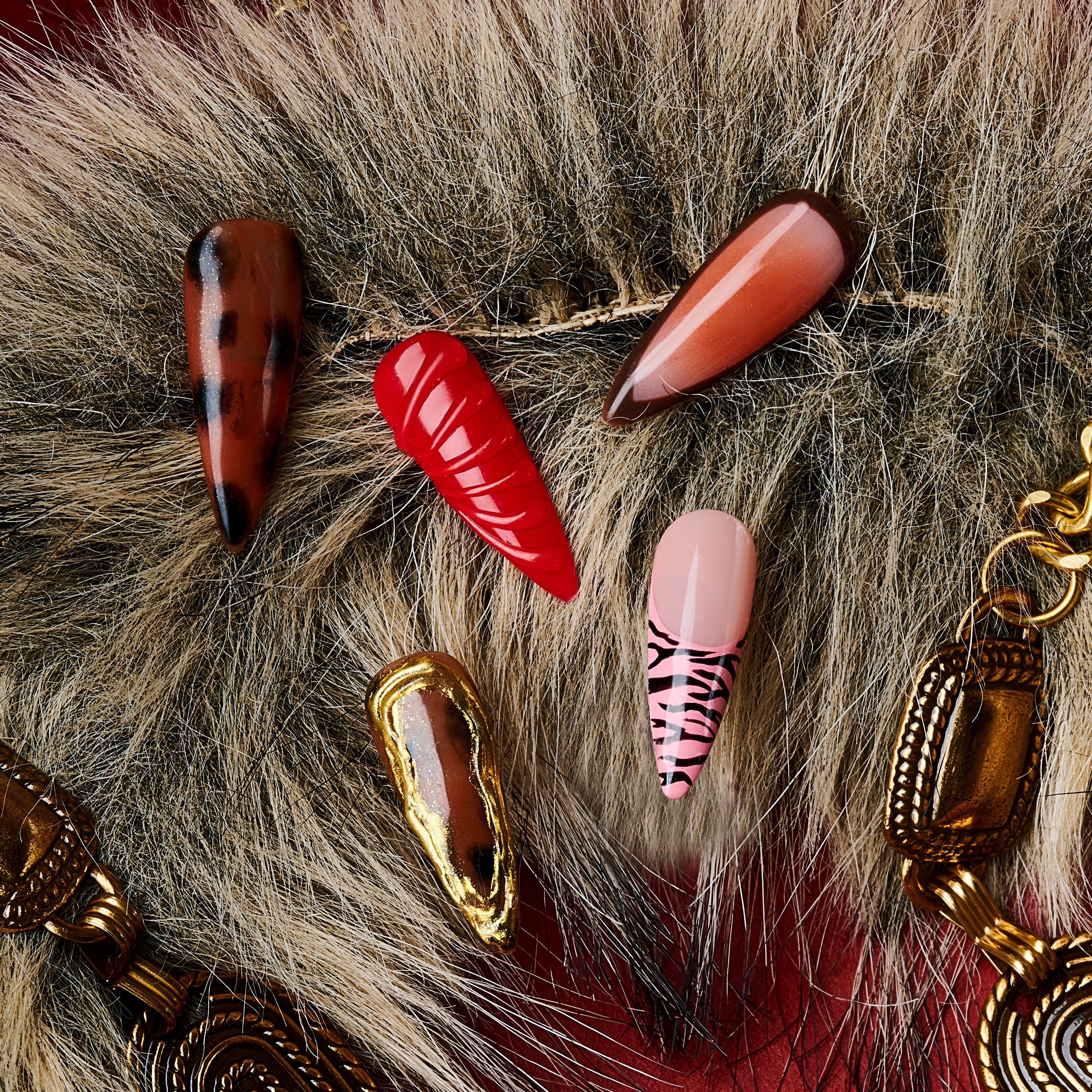 Fiery Flow press on nails with red marble, animal print, and gold-frame accents
