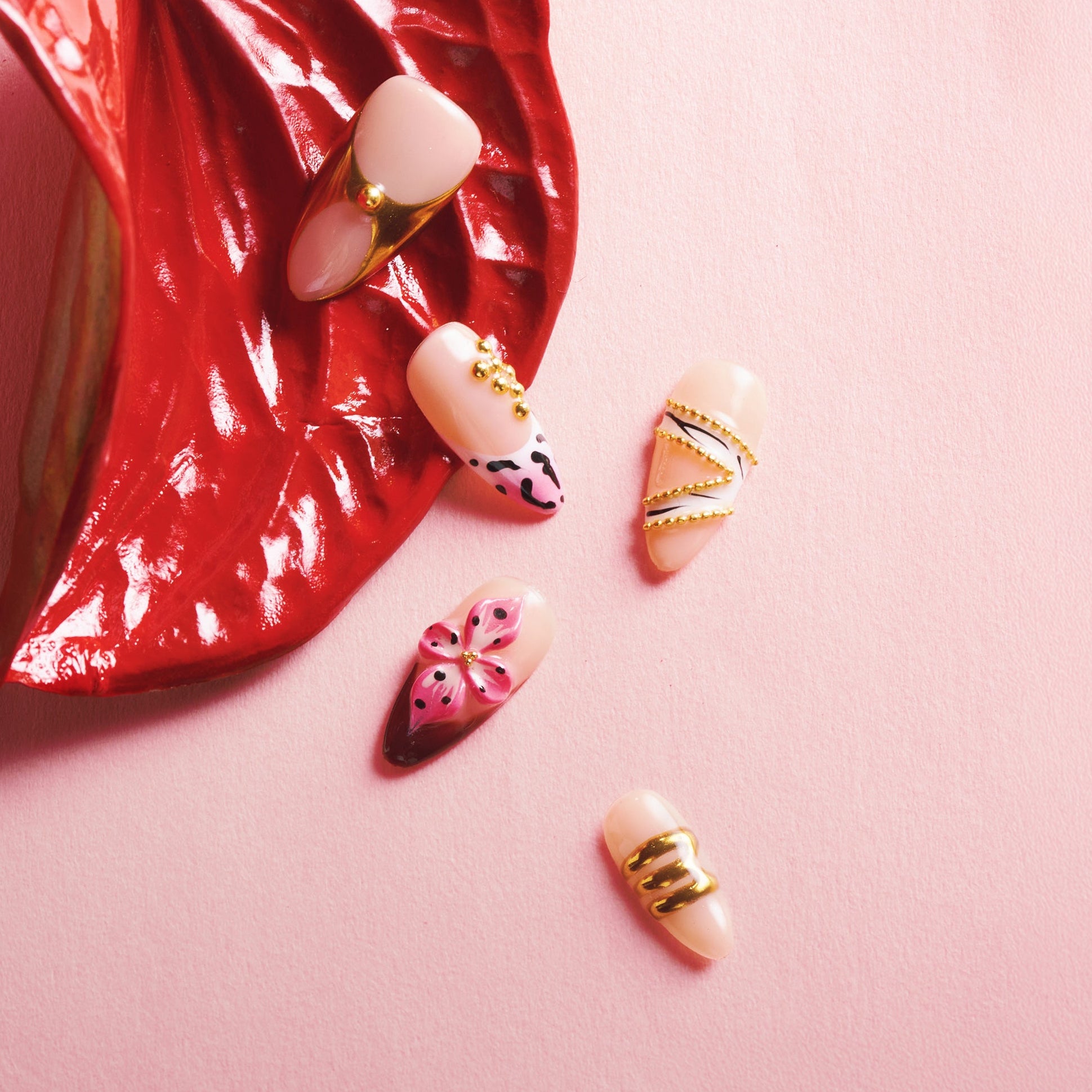 Nude and gold luxury press on nails with sculptural texture. Handmade reusable nail art set with modern elegance.