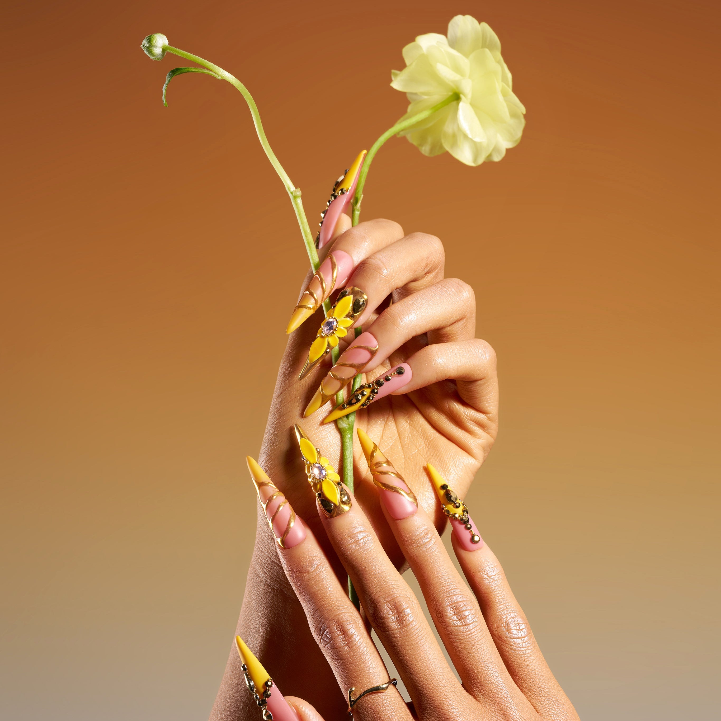 Luxury gold butterfly press on nails with gemstone accents. Dramatic stiletto shape and reusable salon finish.