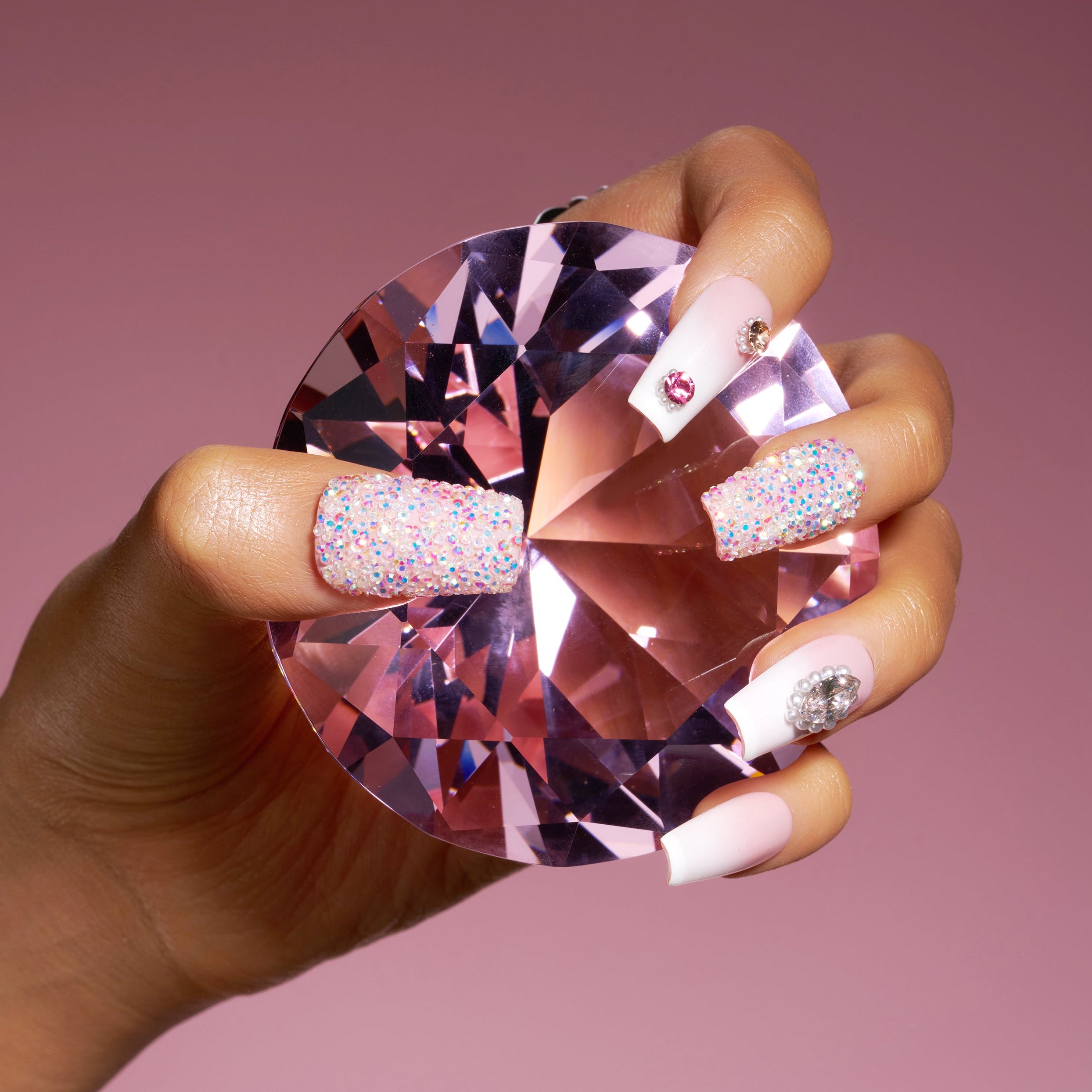 Elegant white pearl press on nails with gold detailing and shell textures. Refined and reusable.