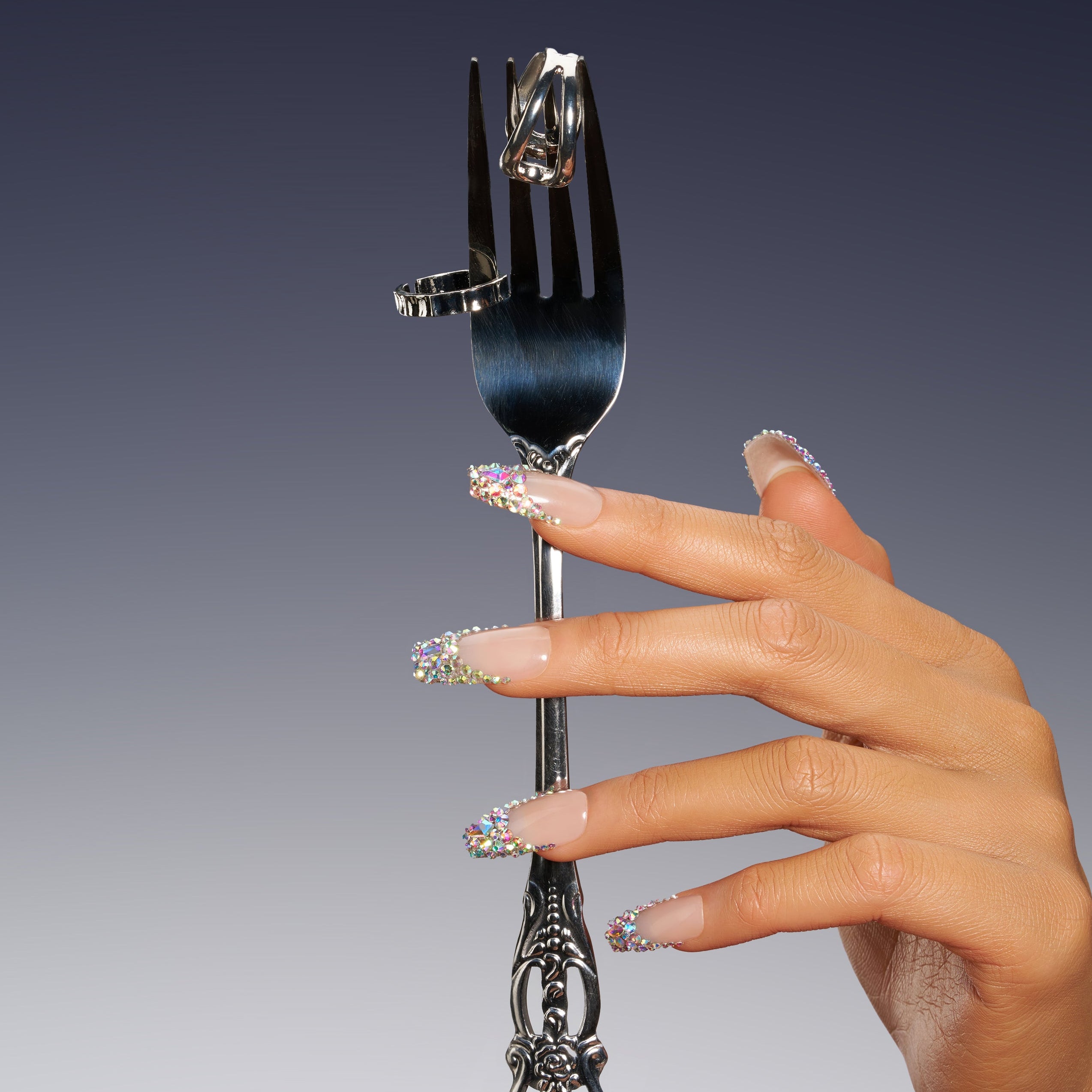 Luxury nude pink press on nails with oversized iridescent crystals and rhinestone detailing. Glamorous and reusable.