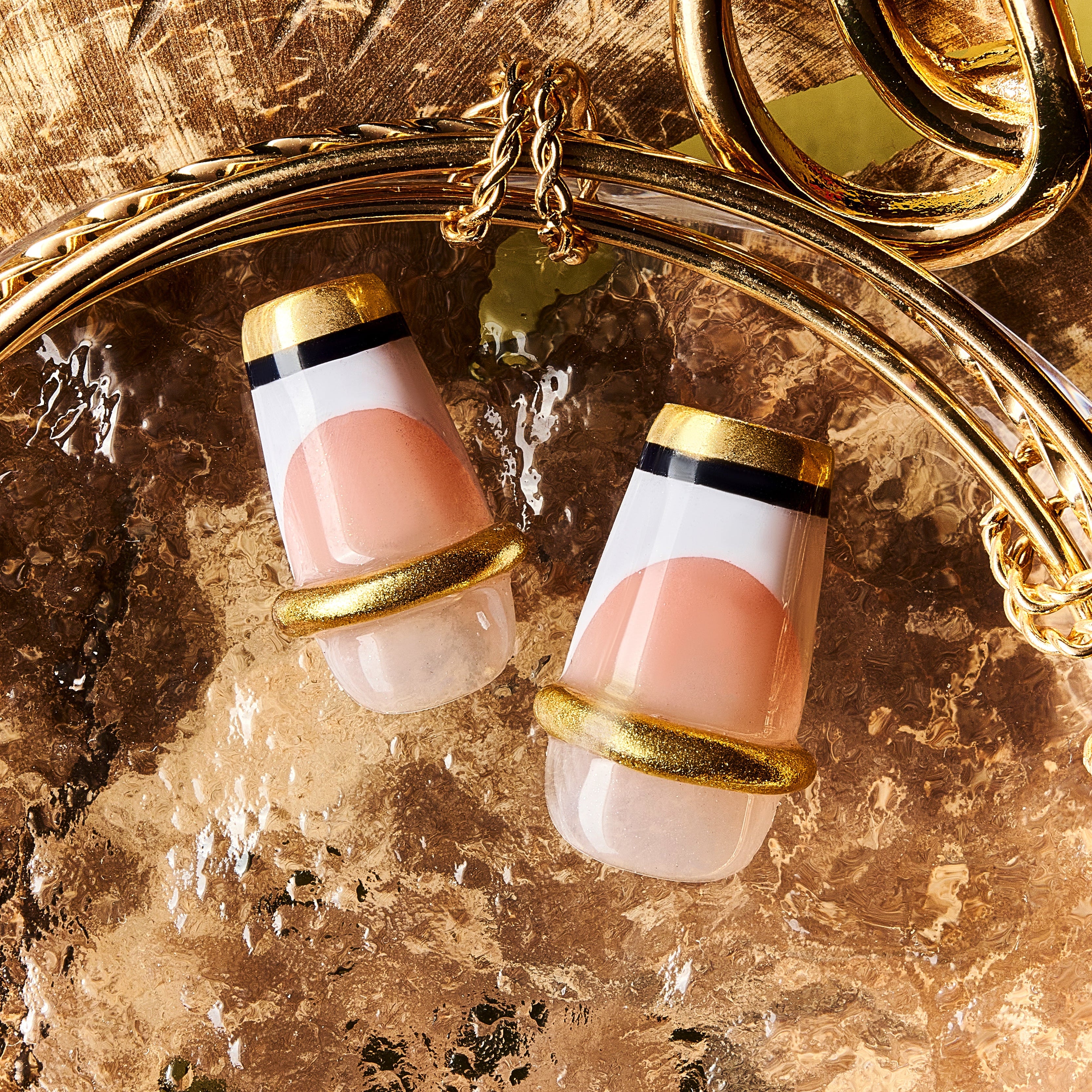 Nude Glow Trim press on nails with gold capsule-style French design