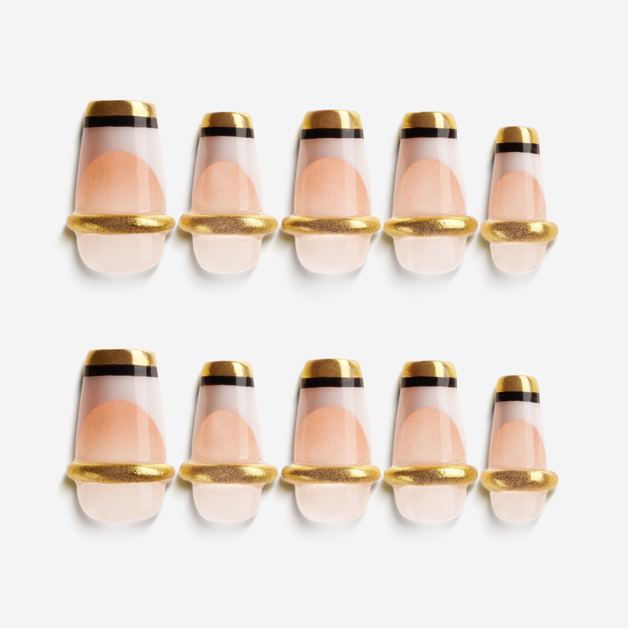 Nude Glow Trim press on nails with gold capsule-style French design