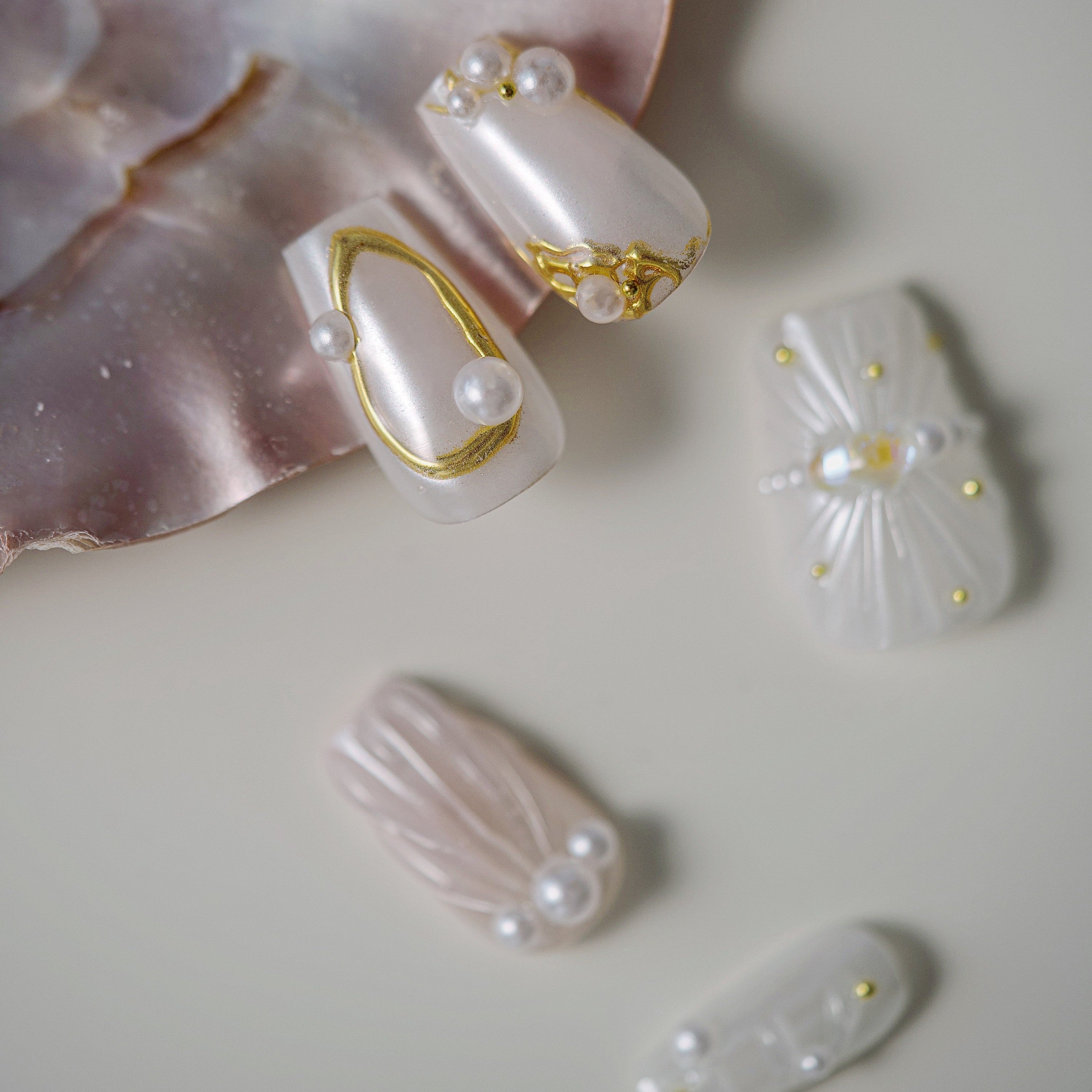 Pink ombre glitter press on nails with opalescent crystal detailing. Romantic sparkle and reusable design.