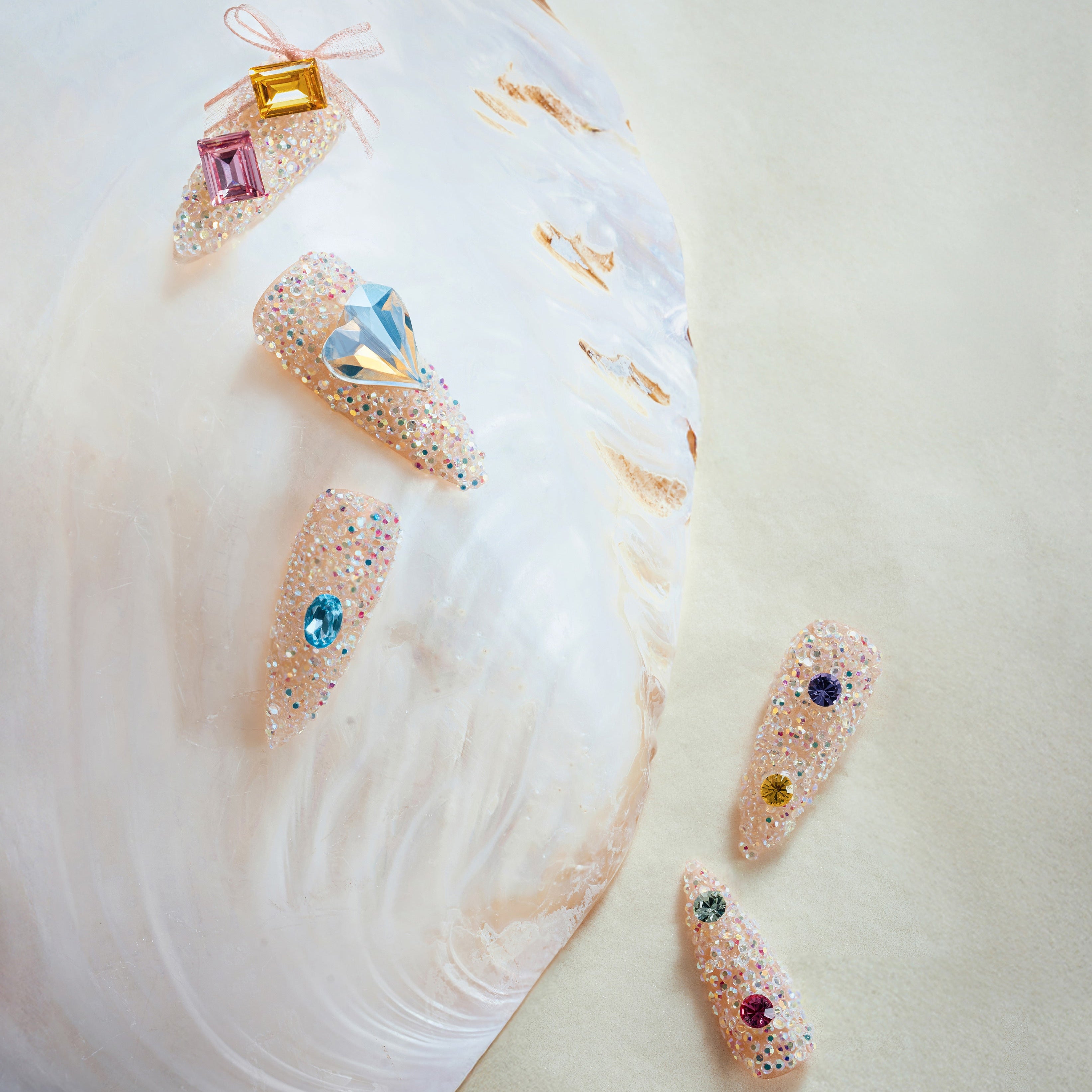 Almond luxury press on nails featuring genuine Swarovski® crystals. Handmade reusable high-shine nail set.