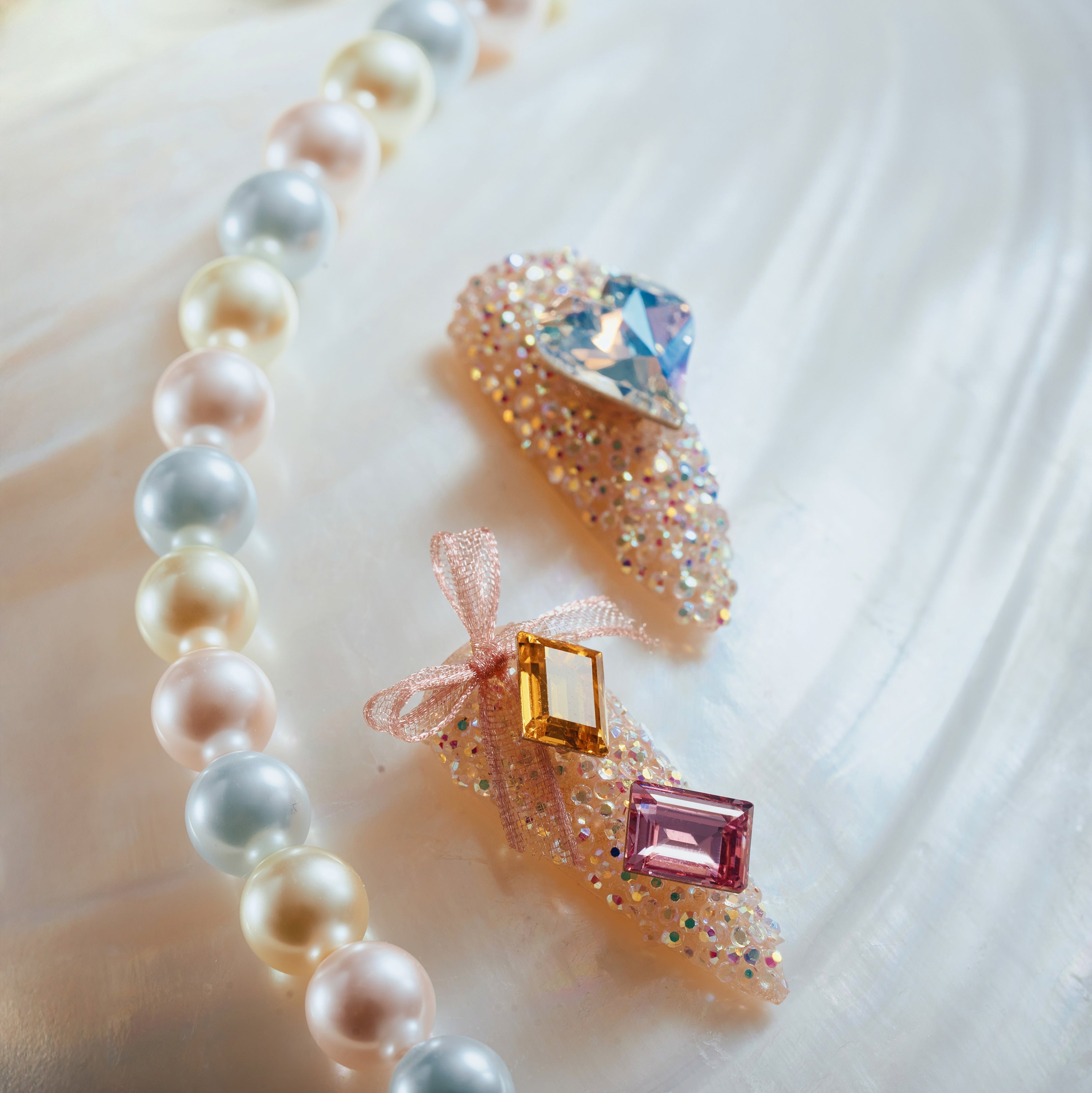 Almond luxury press on nails featuring genuine Swarovski® crystals. Handmade reusable high-shine nail set.