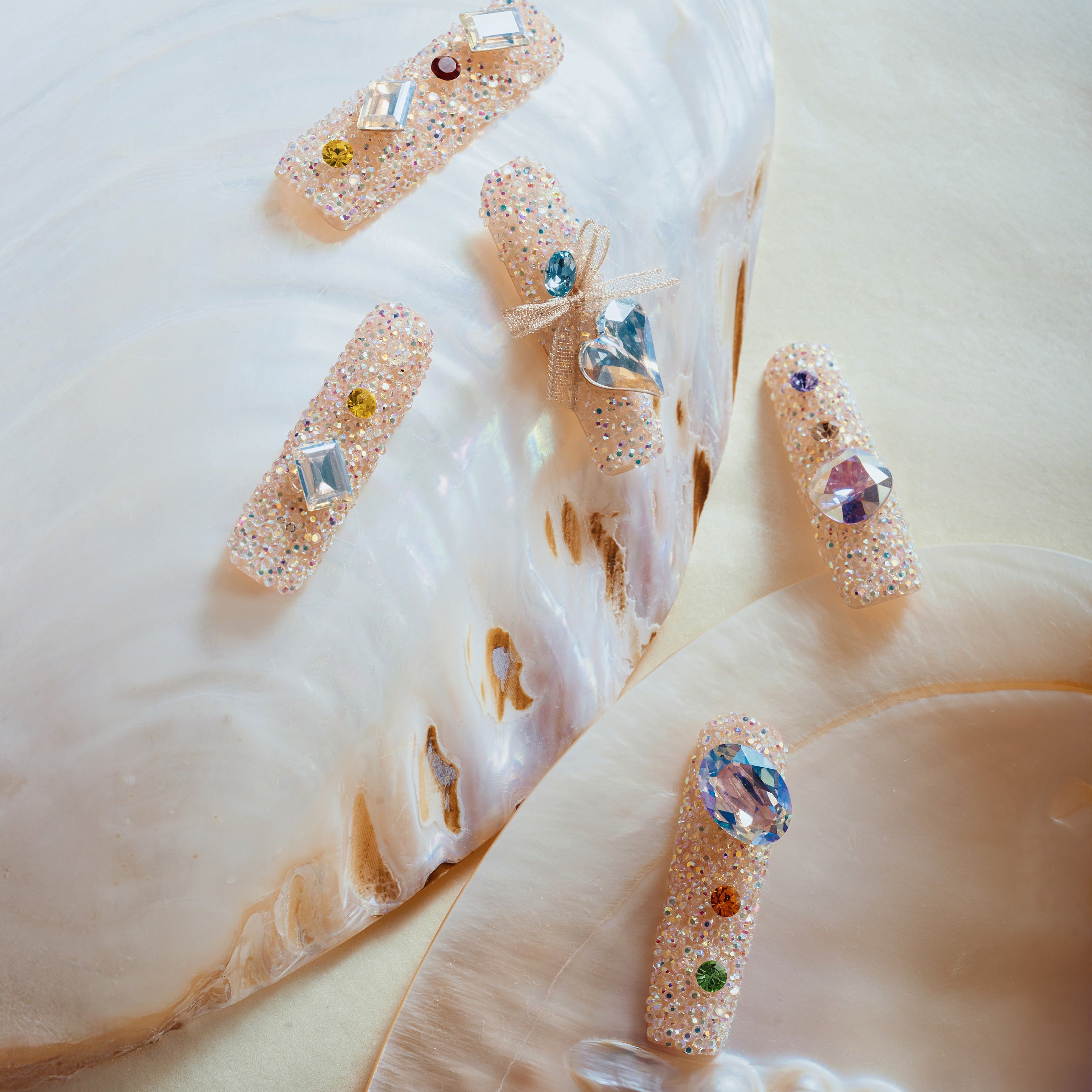 Luxury press on nails featuring genuine Swarovski® crystals. High-shine glam reusable nail art set.