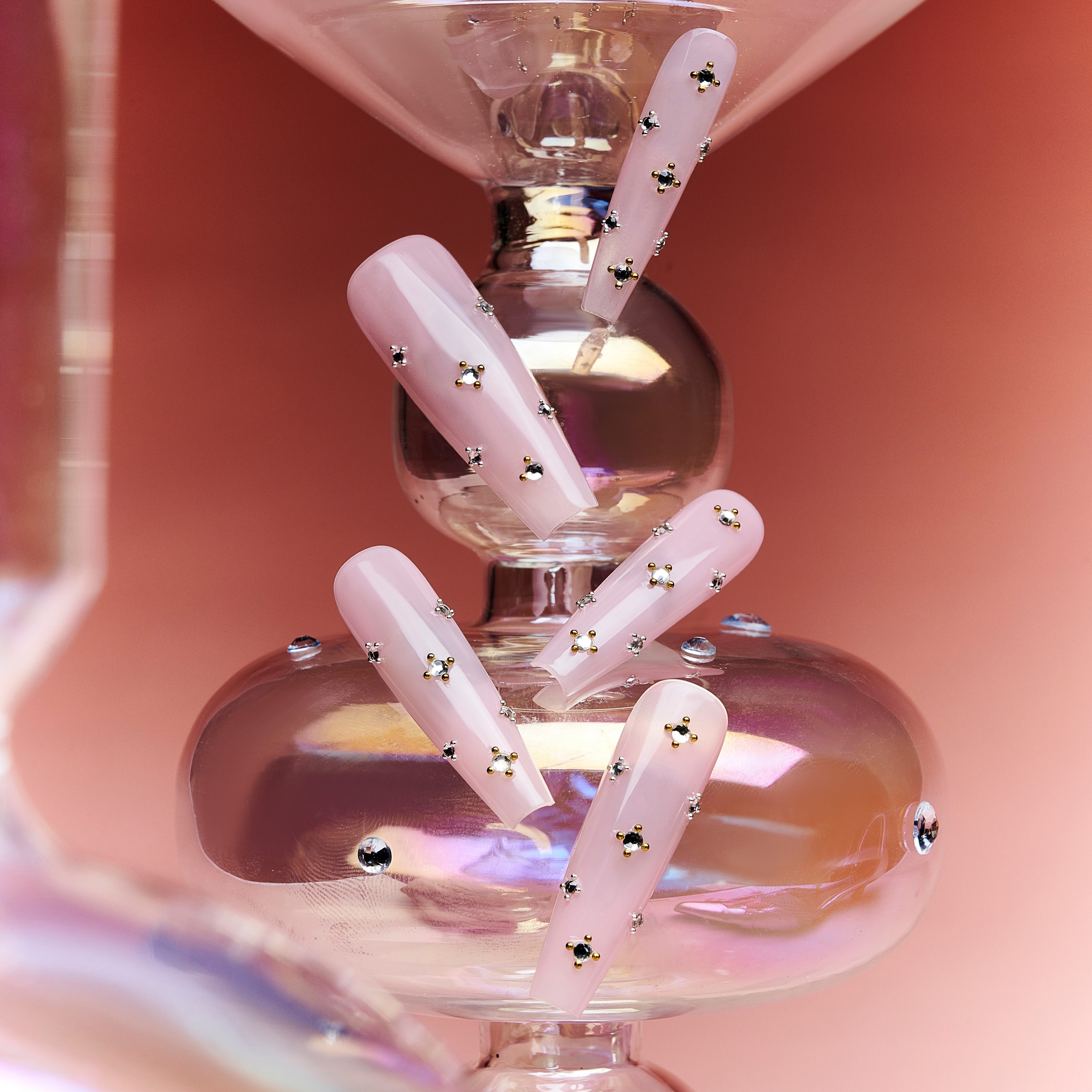 Elegant pink press on nails with crystal gem details. Glossy coffin shape, reusable and perfect for chic everyday glam.