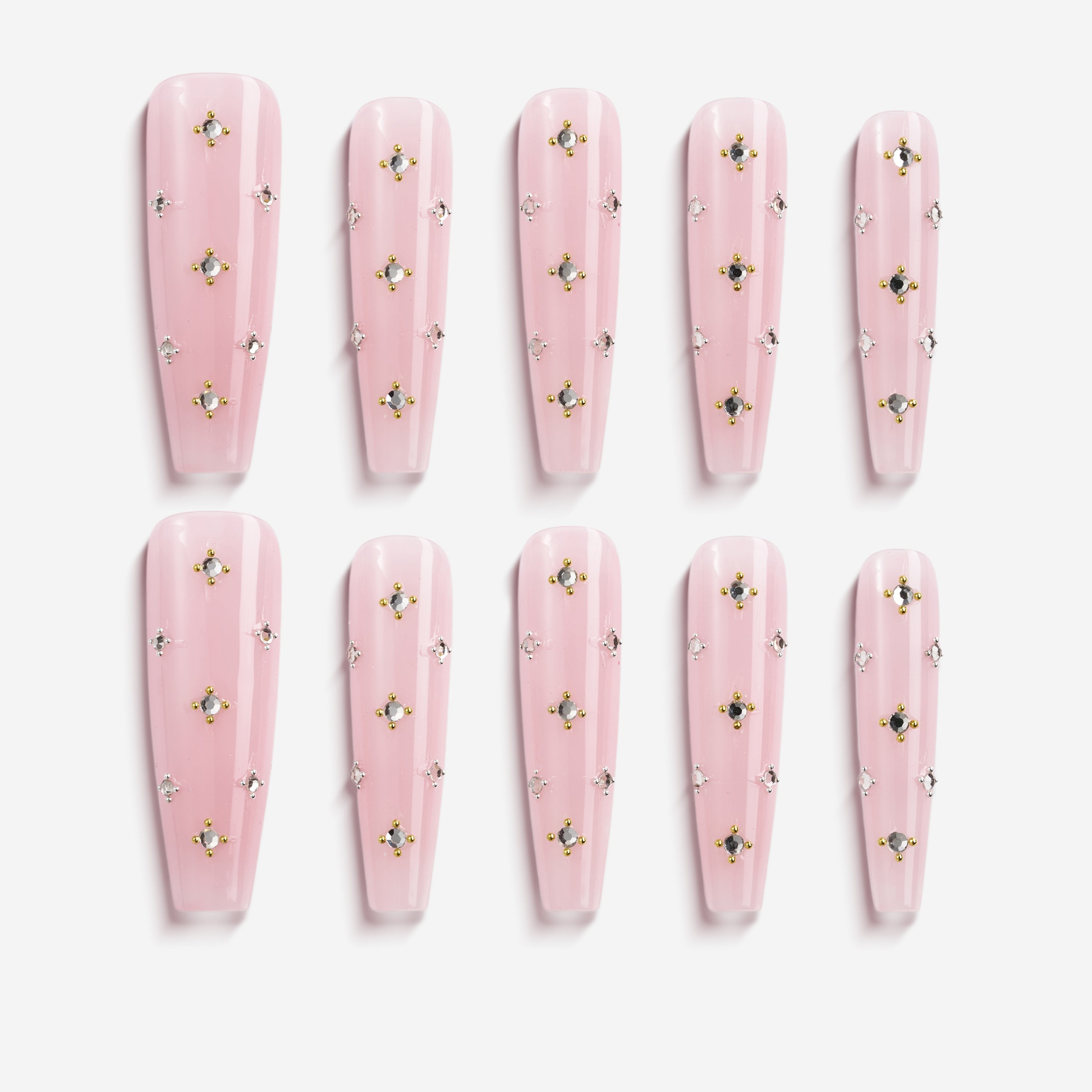 Elegant pink press on nails with crystal gem details. Glossy coffin shape, reusable and perfect for chic everyday glam.