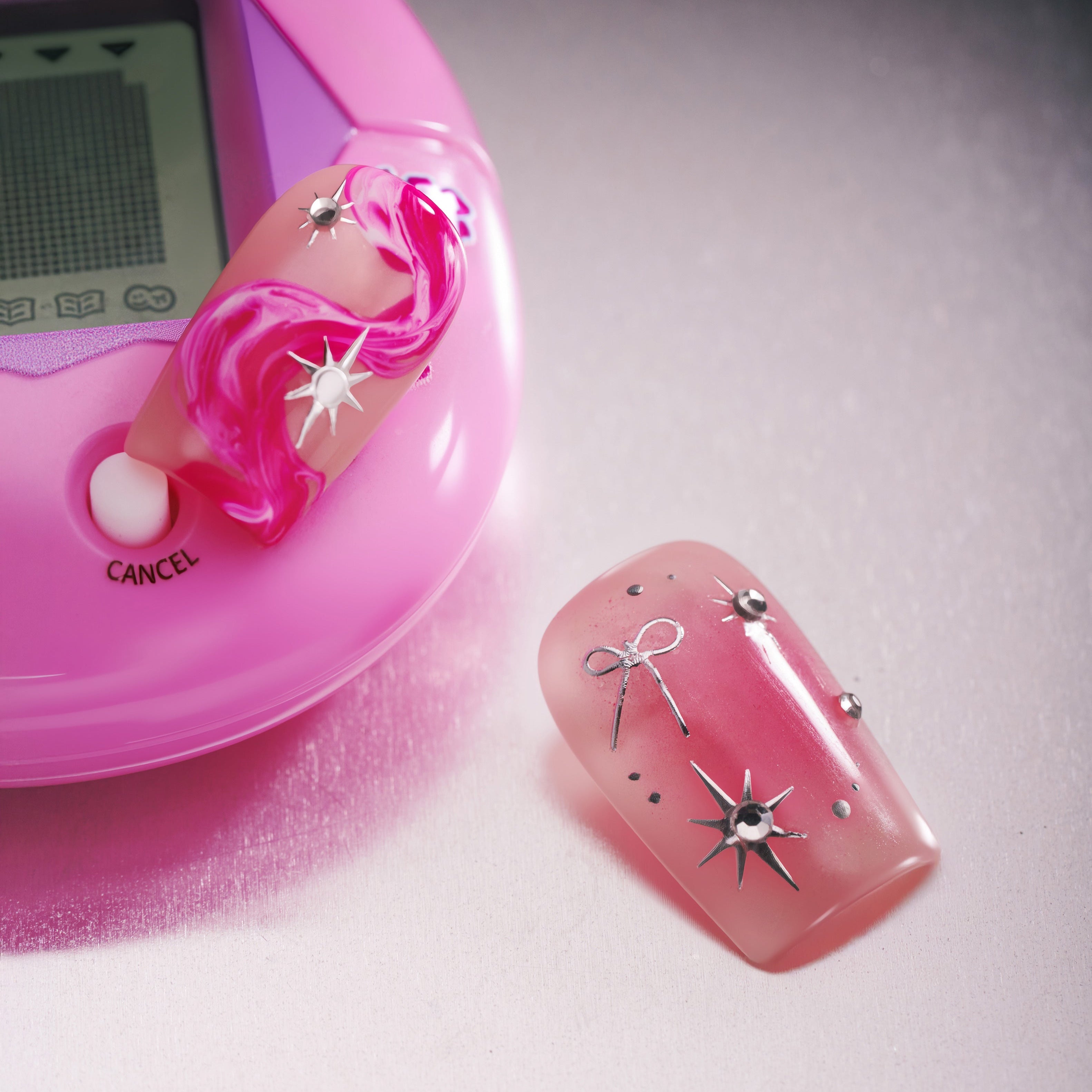 Radiant Sheen press on nails in square shape with pink glow and silver accents