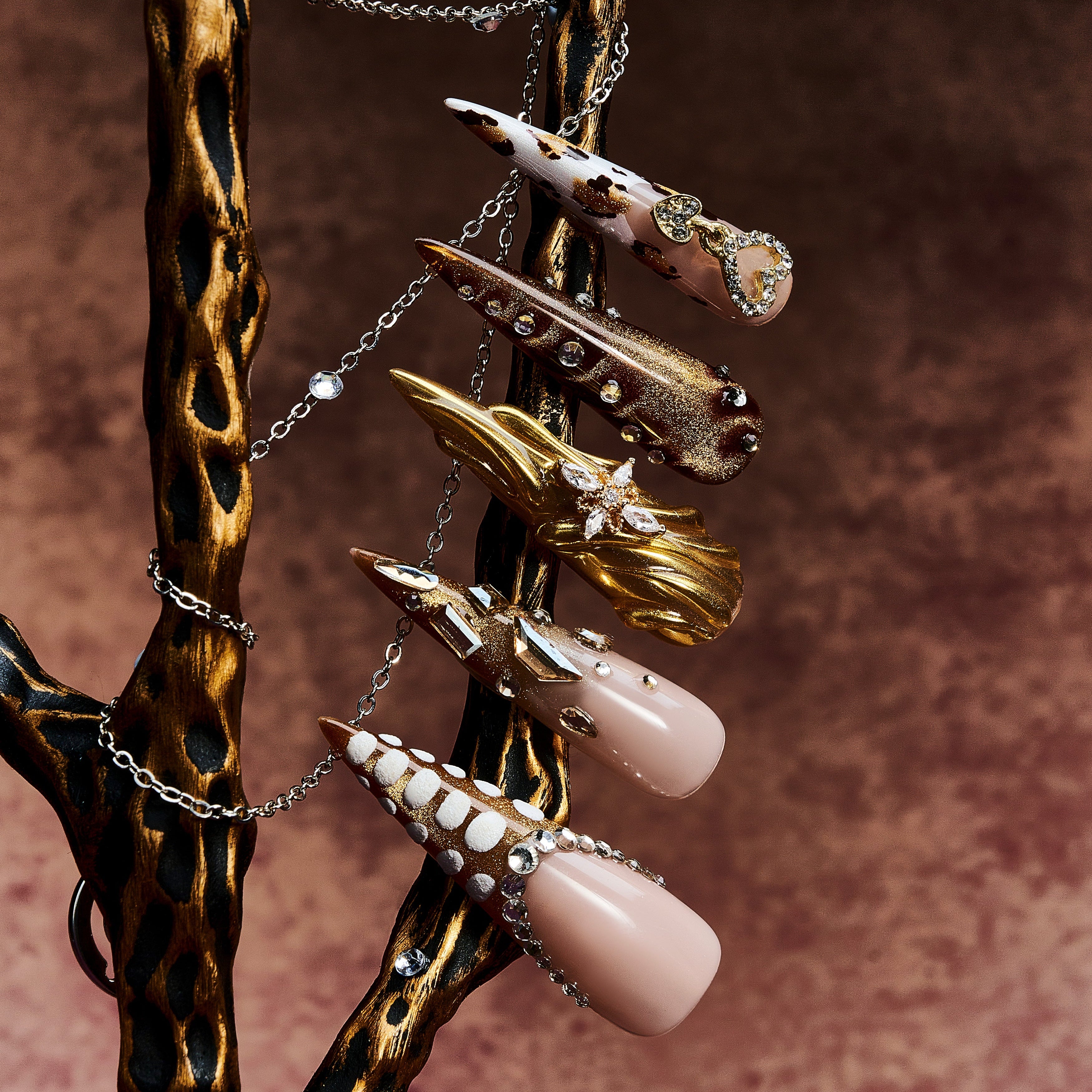 Jewel-inspired luxury press on nails with intricate gemstone arrangements. Handmade reusable nail art set.