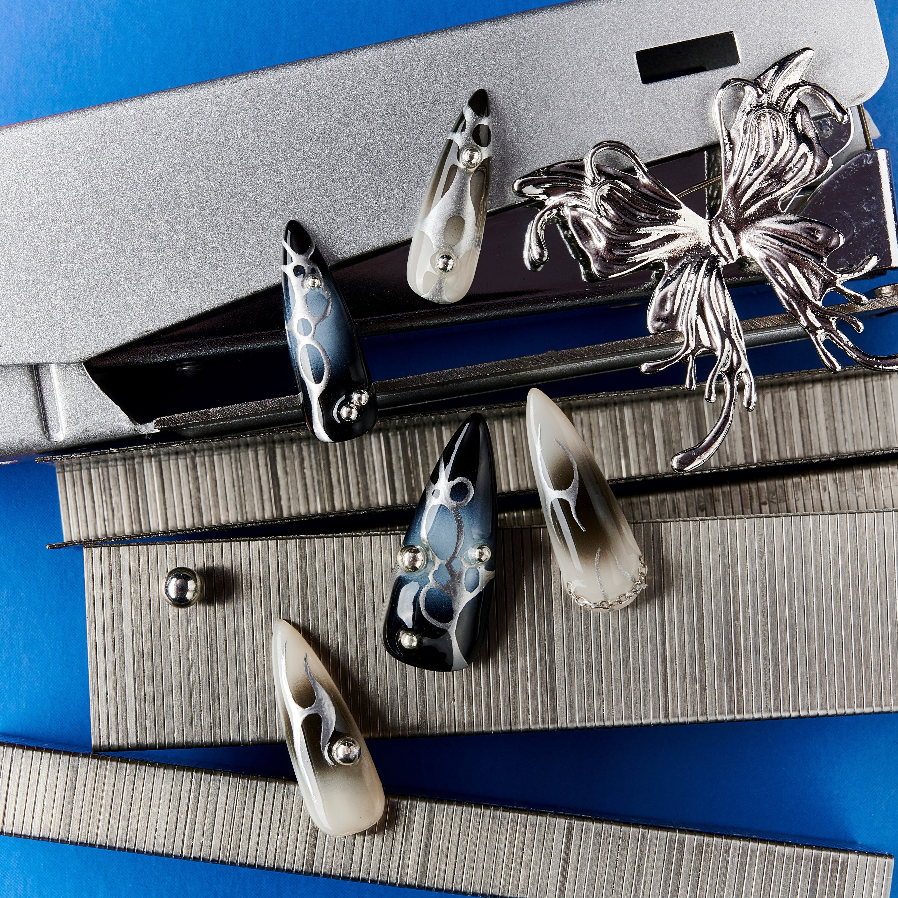 Shadowy Fantasy Vein press-on nails with black-to-blue ombré, metallic chains, and gothic cross embellishments