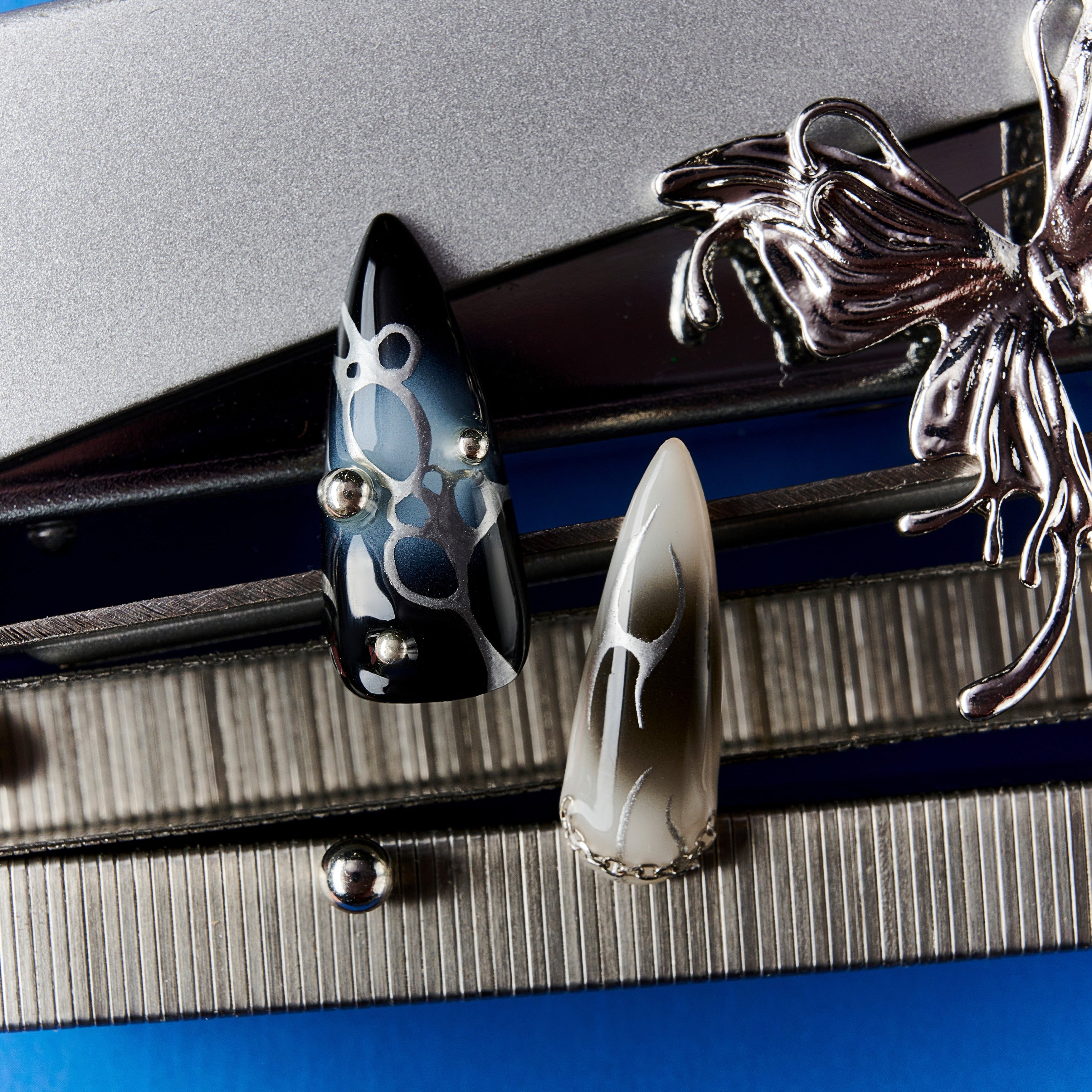 Shadowy Fantasy Vein press-on nails with black-to-blue ombré, metallic chains, and gothic cross embellishments