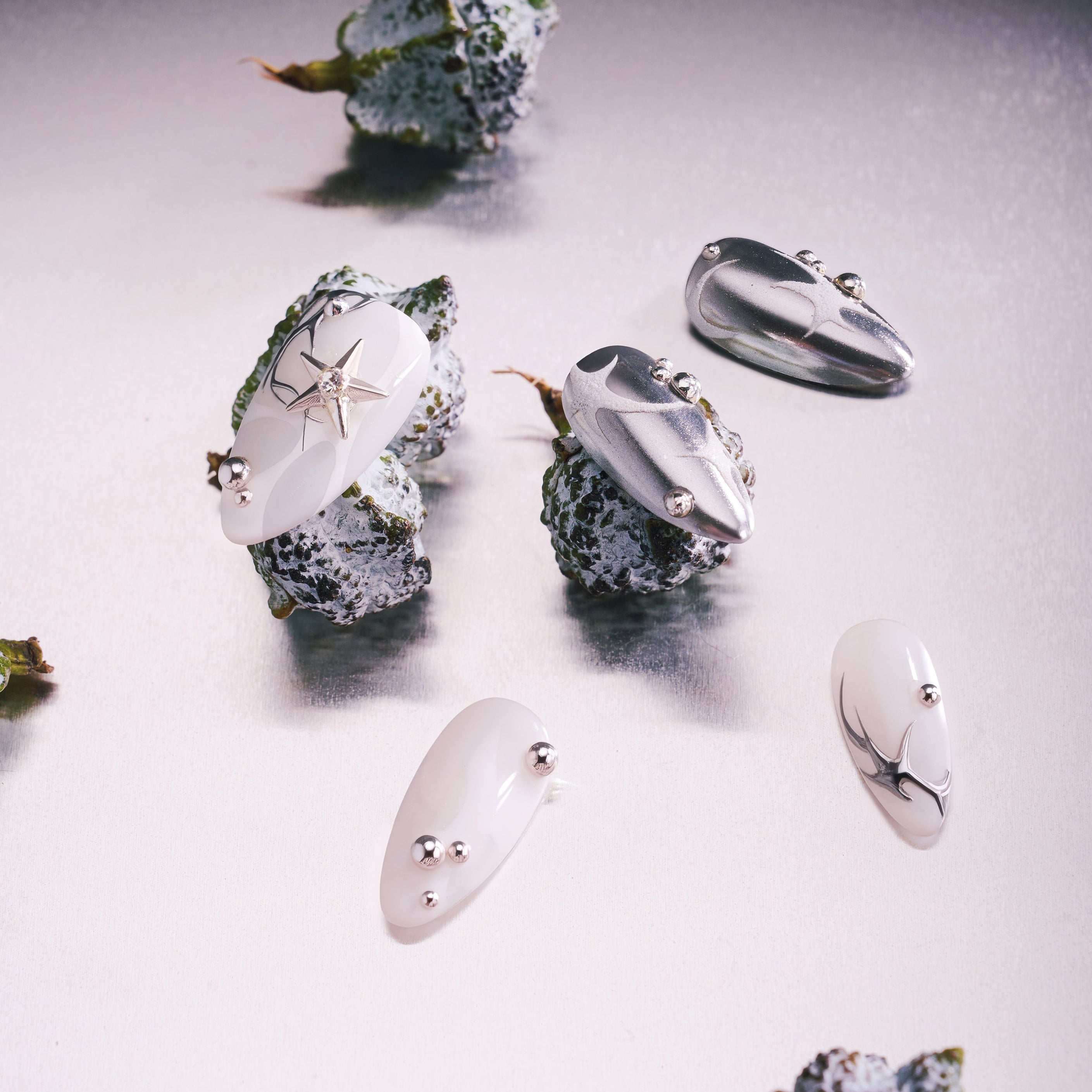 Silver Mystique metallic press on nails with abstract chrome textures.