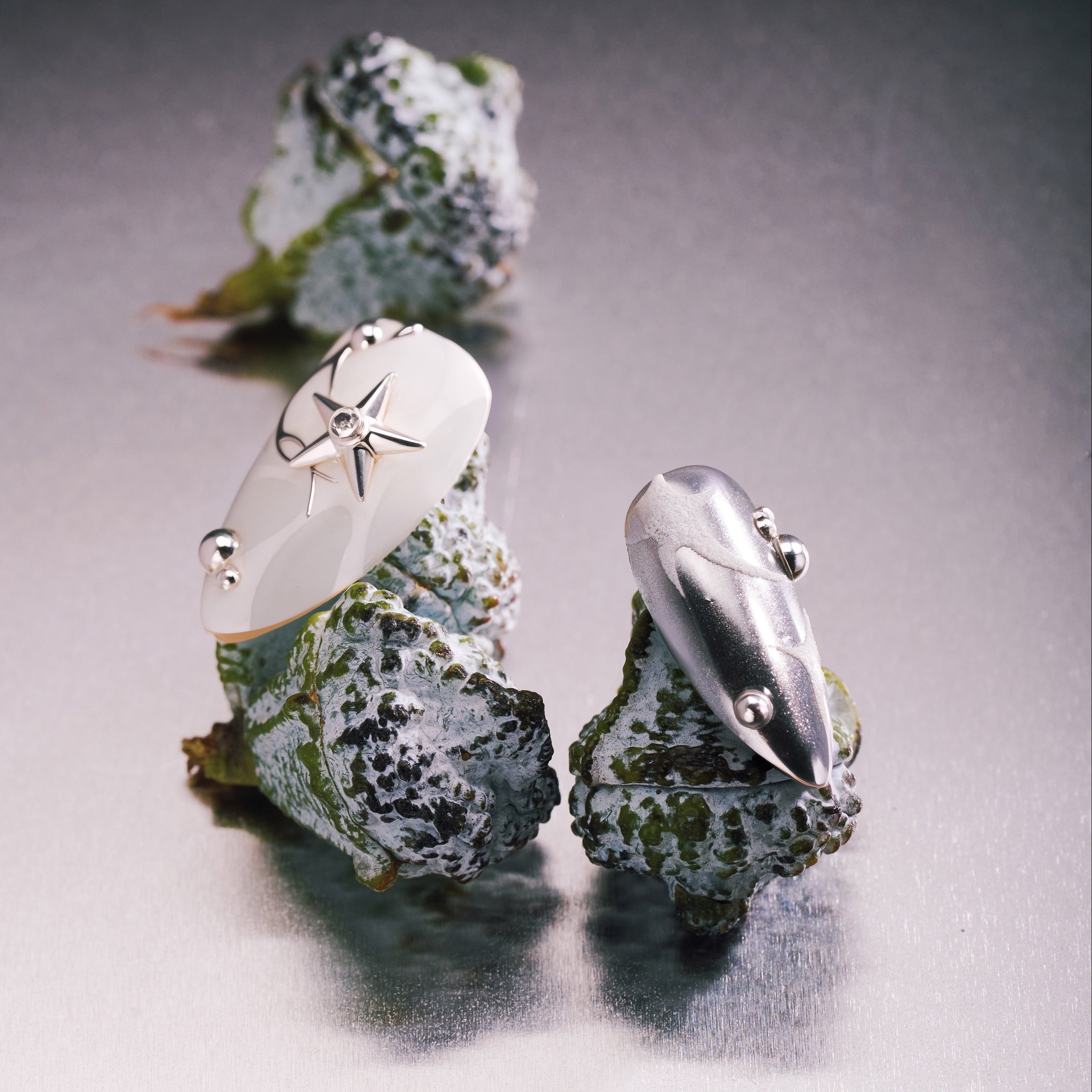 Silver Mystique metallic press on nails with abstract chrome textures.