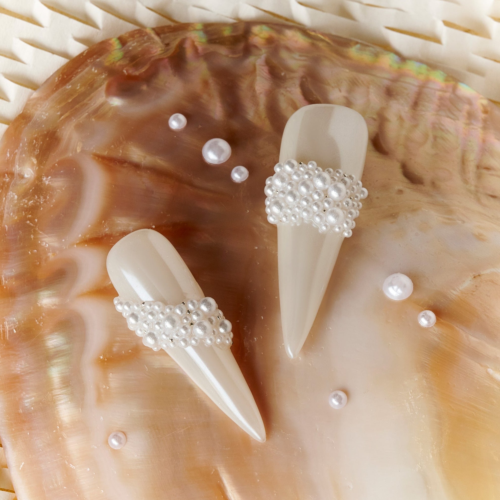 Starry Tips white stiletto press on nails decorated with pearl cluster accents.