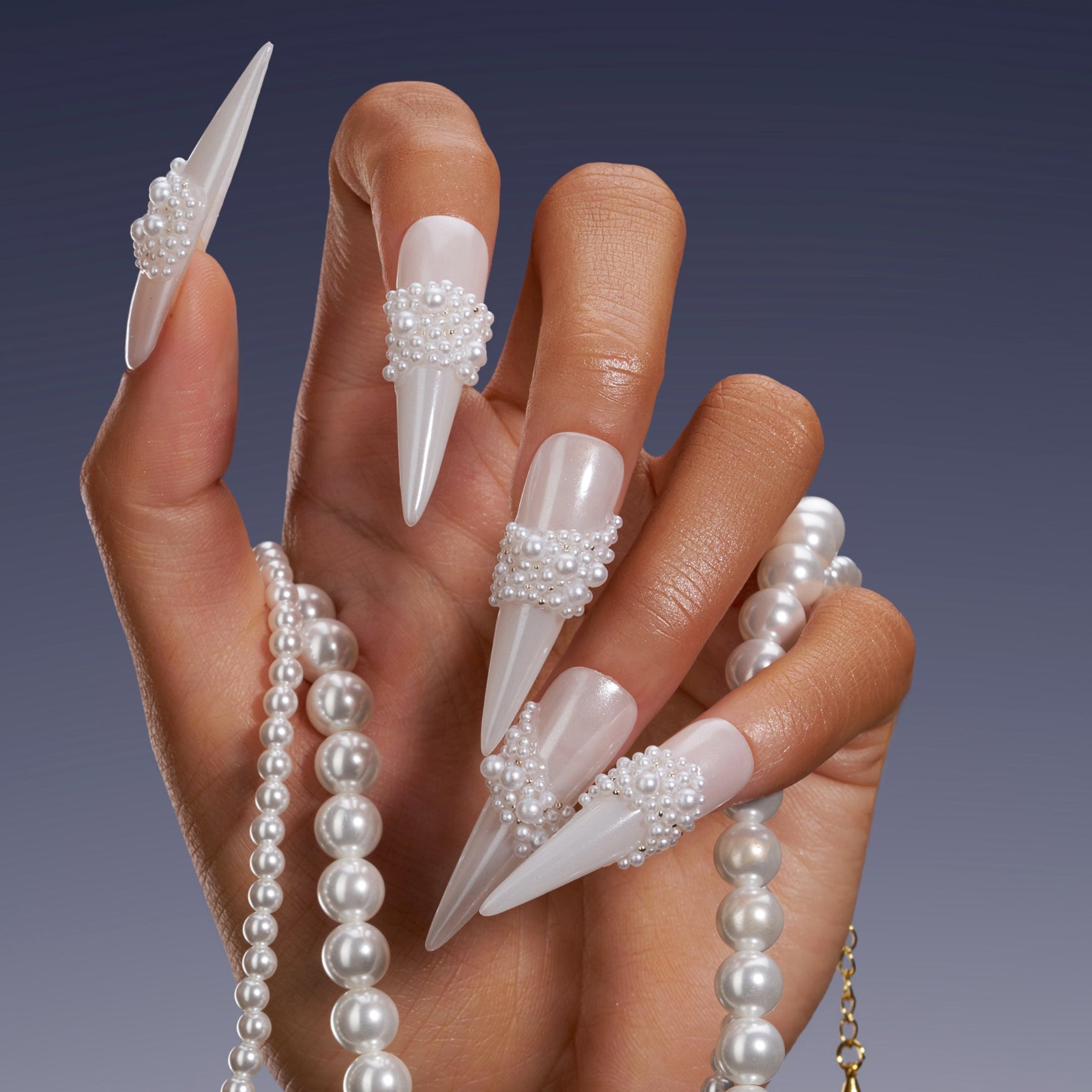 Starry Tips white stiletto press on nails decorated with pearl cluster accents.