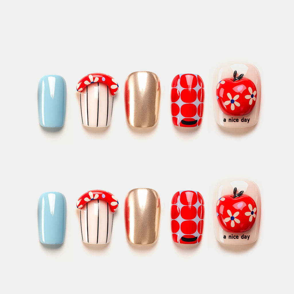 Apple Paradise – red apple and gold Christmas press-on nails with pop art design and playful holiday theme
