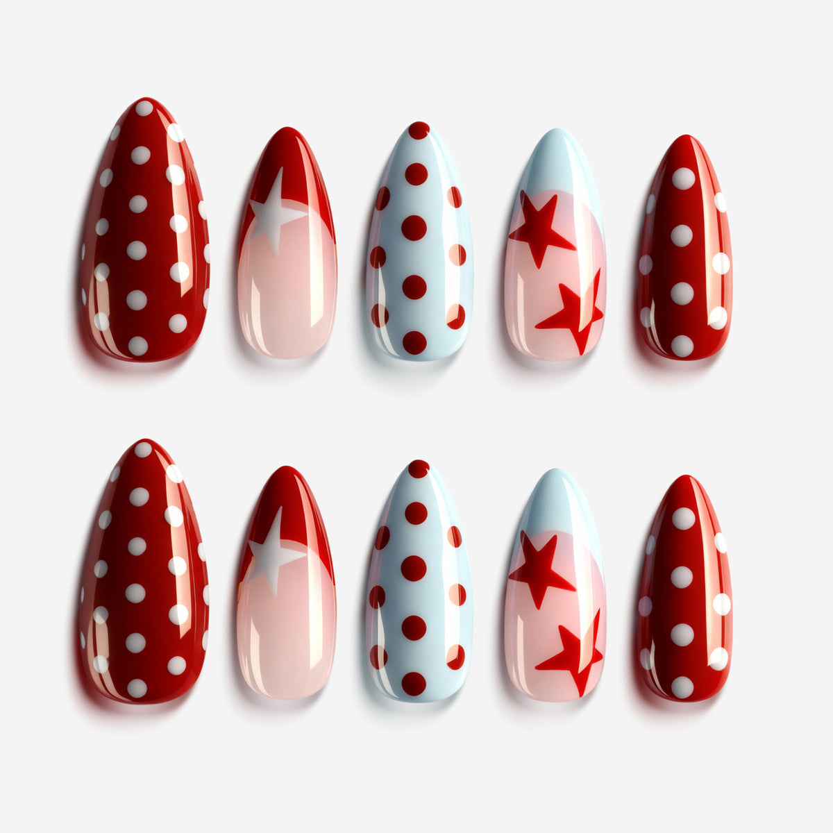 Berry star sparkle press on nails with red polka dots, soft pink base, blue accents and star patterns.