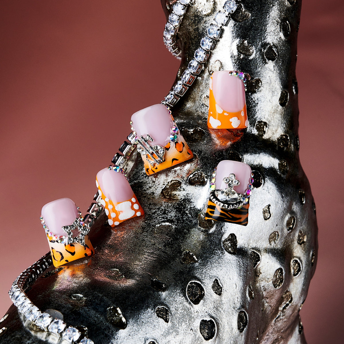 Butterfly mirage press on nails with leopard prints, pastel tips, rhinestones, and silver butterfly charms.