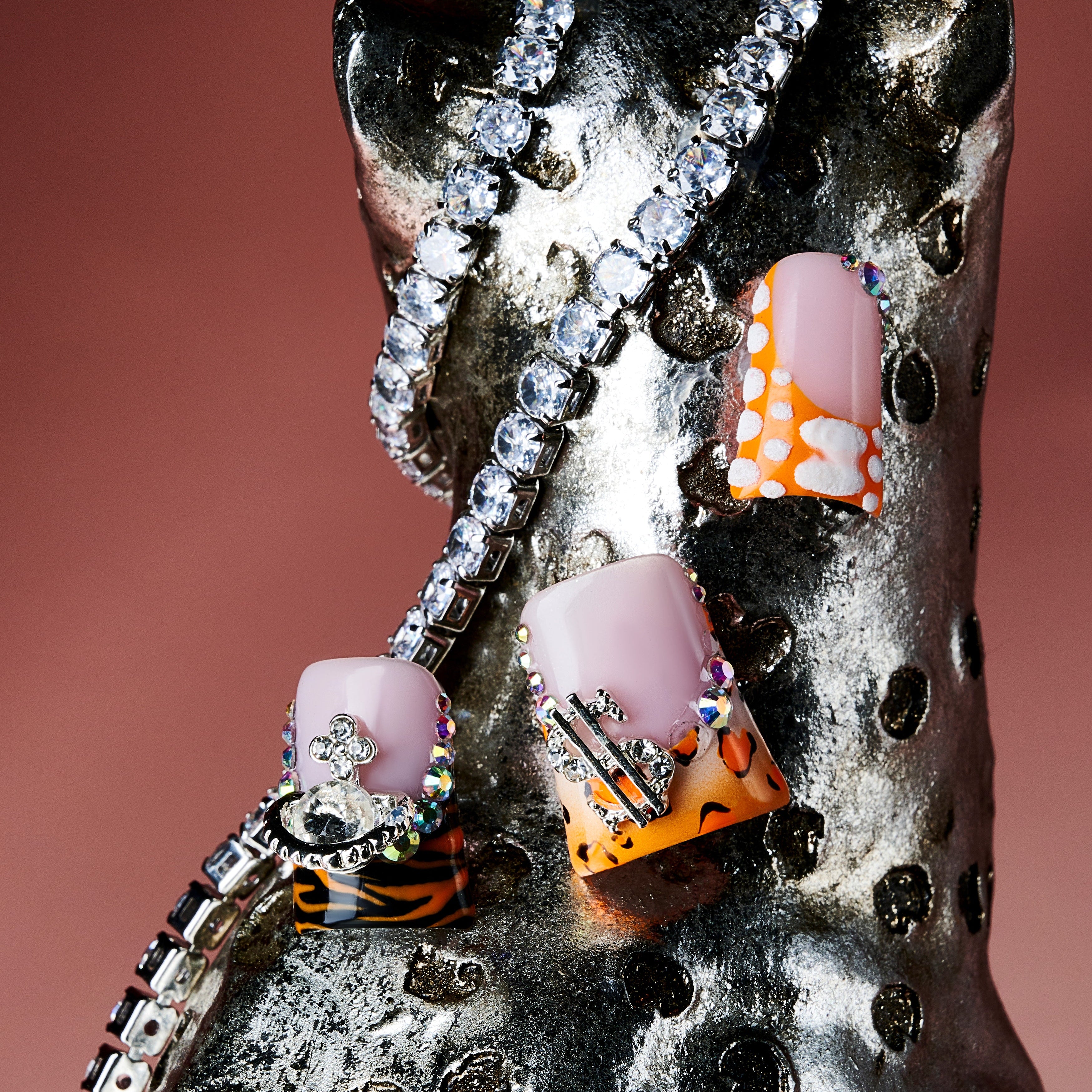 Butterfly mirage press on nails with leopard prints, pastel tips, rhinestones, and silver butterfly charms.