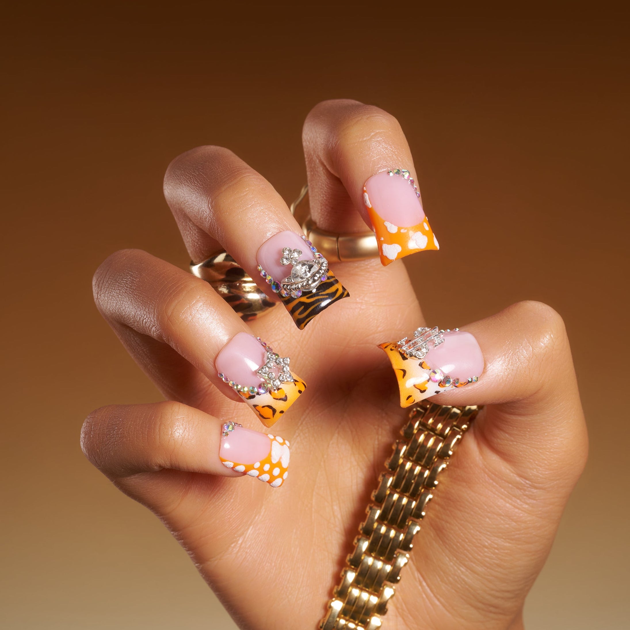 Butterfly mirage press on nails with leopard prints, pastel tips, rhinestones, and silver butterfly charms.