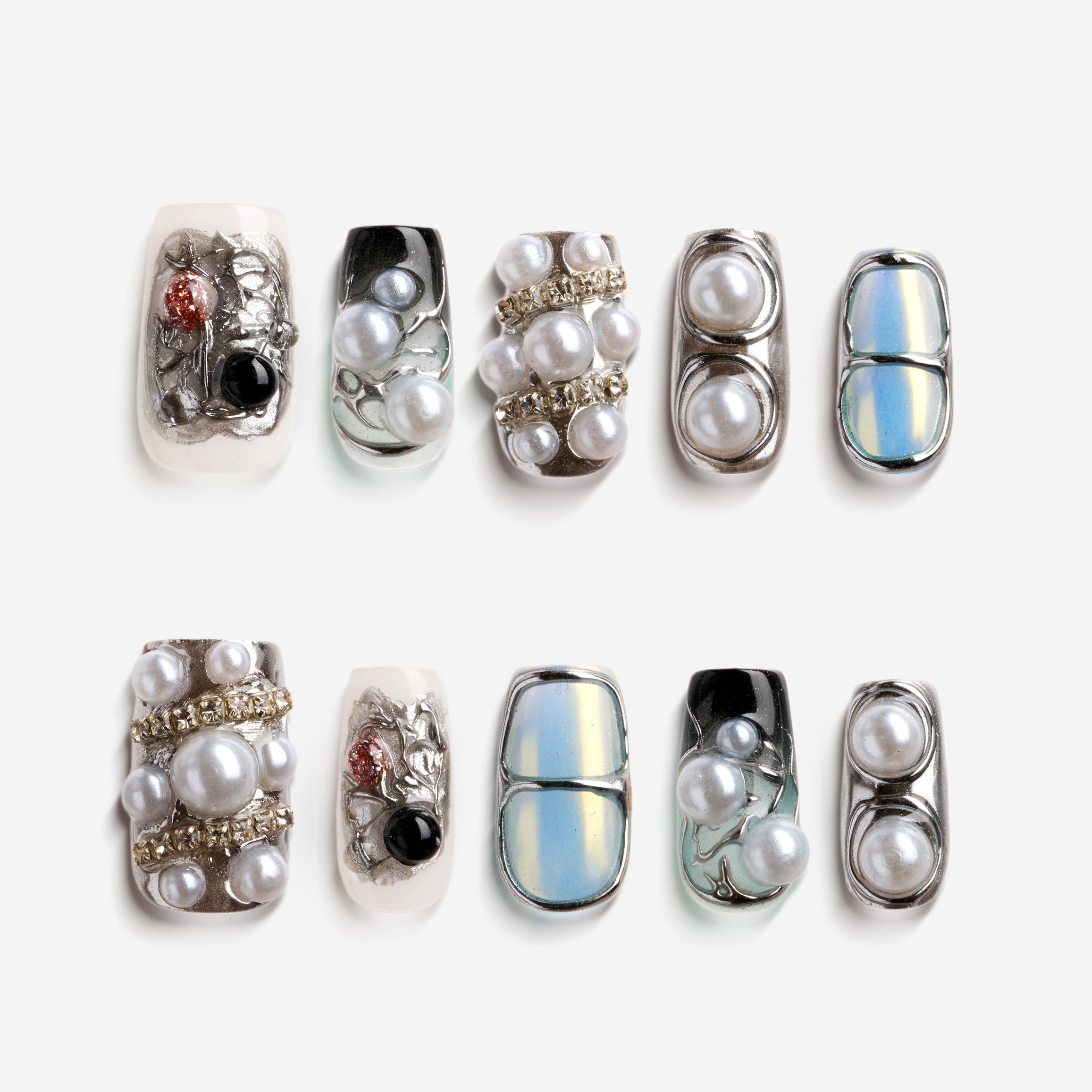 Cyber-style press on nails with chrome metallic finish, pearl embellishments and futuristic design.