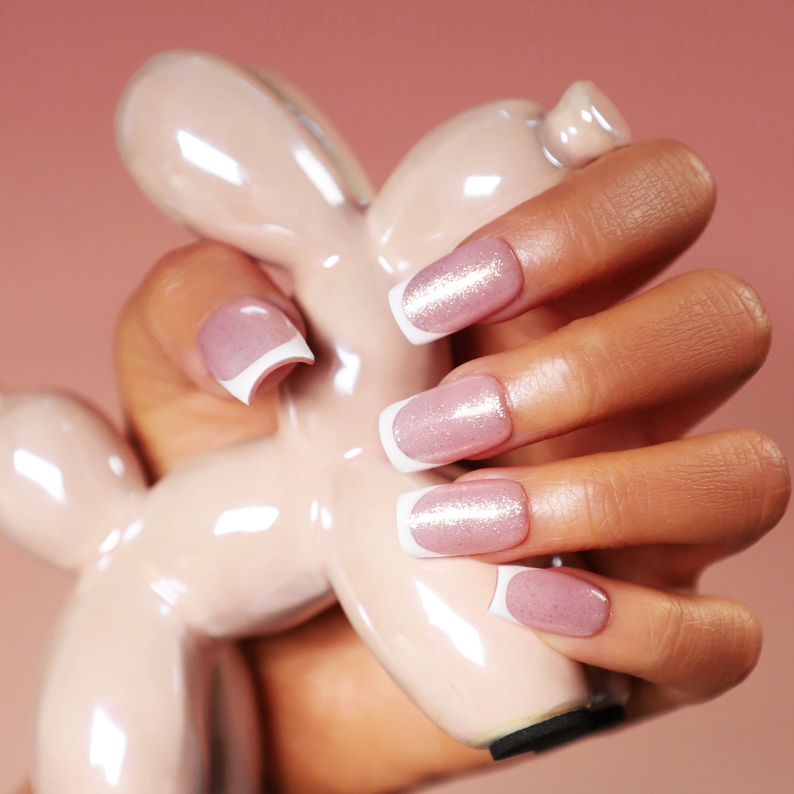 Short square nude press on nails with glossy finish and soft natural tone.
