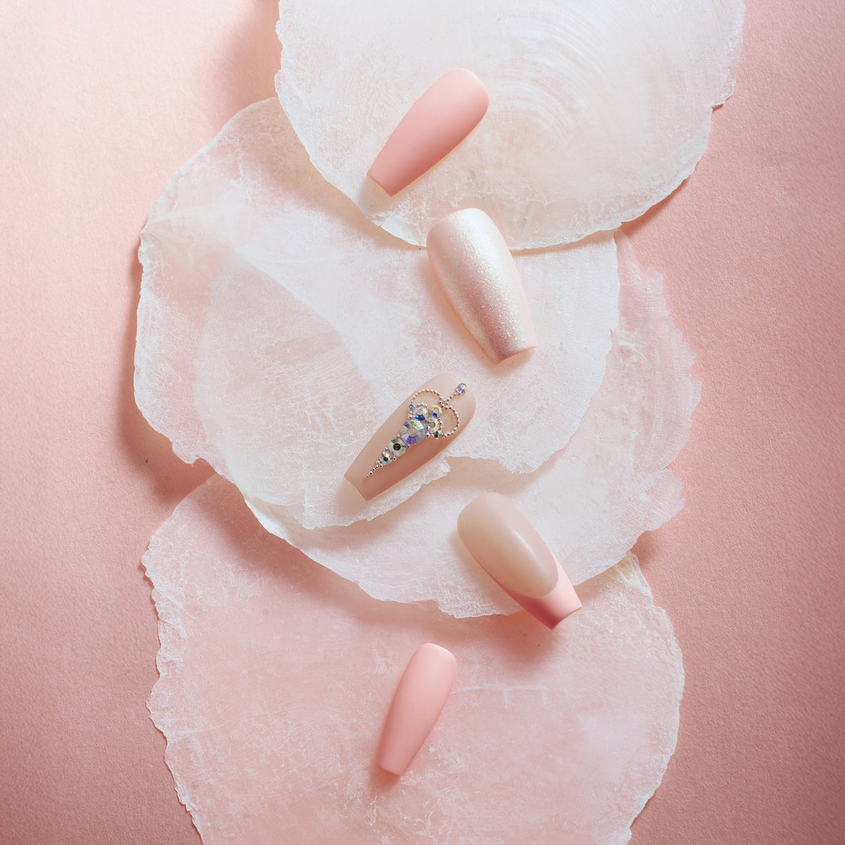 Pink sparkle elegance press on nails with shimmer glitter, nude pink tones, and rhinestone accent nail.