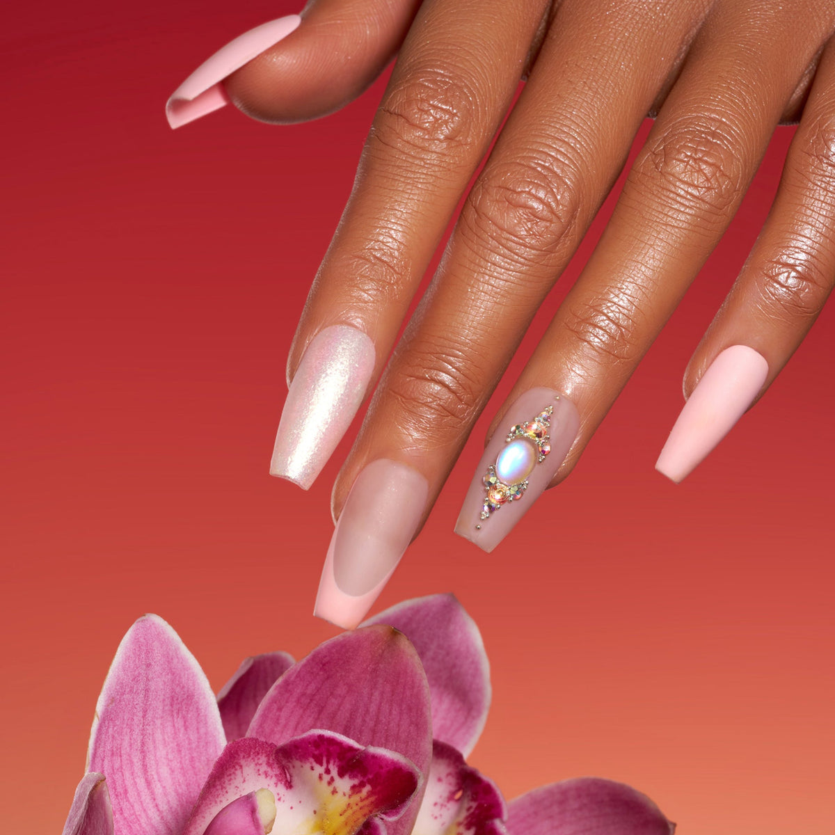 Pink sparkle elegance press on nails with shimmer glitter, nude pink tones, and rhinestone accent nail.