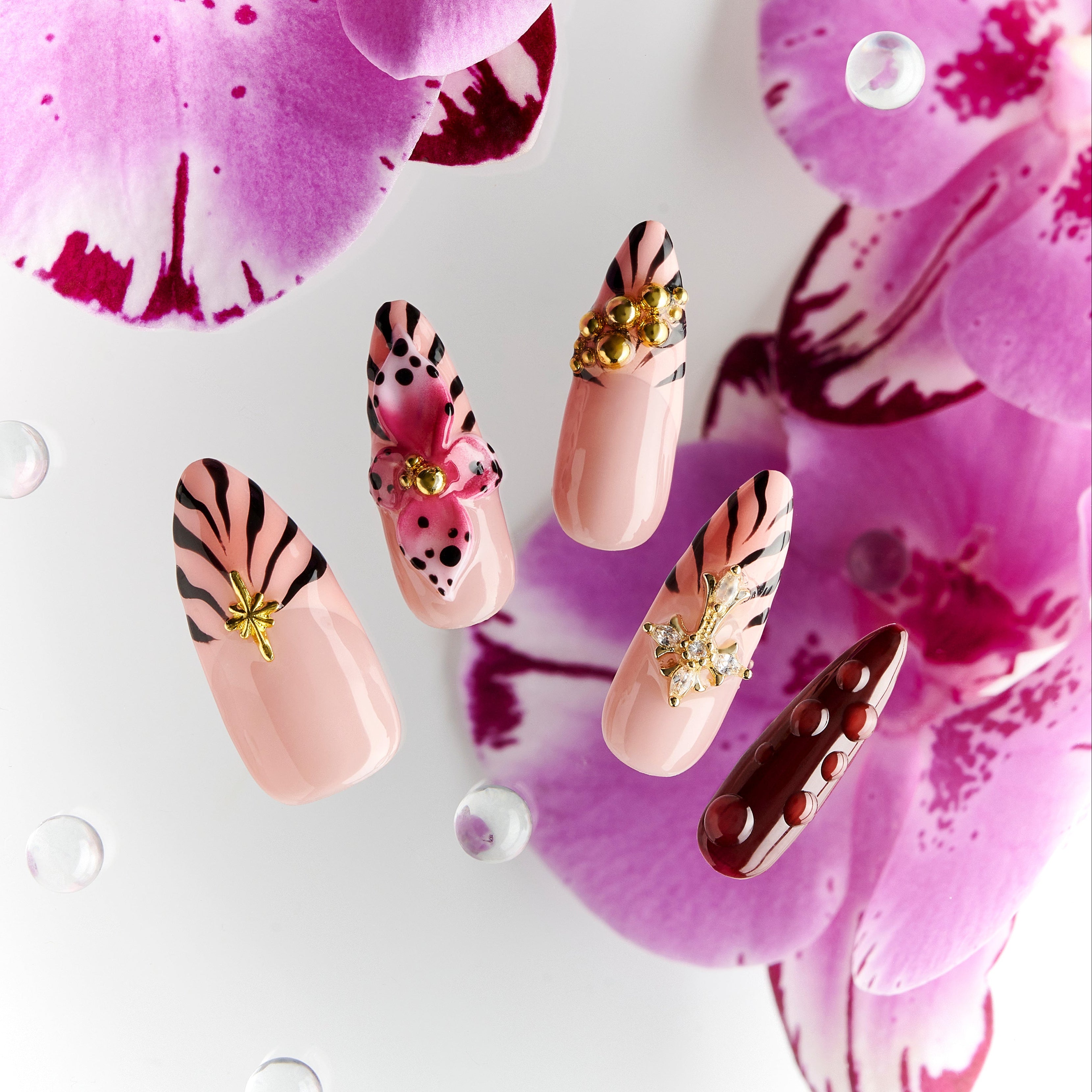 Warm neutral press on nails with gold and crystal details. Handmade reusable nail art set for everyday elegance.