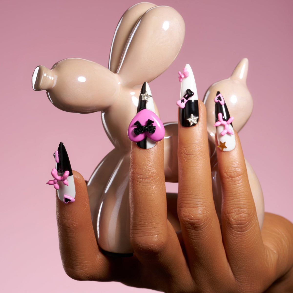 Bold black and white stiletto press on nails with 3D heart accents. Reusable statement nail set.