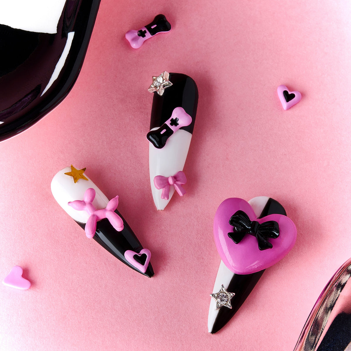 Bold black and white stiletto press on nails with 3D heart accents. Reusable statement nail set.