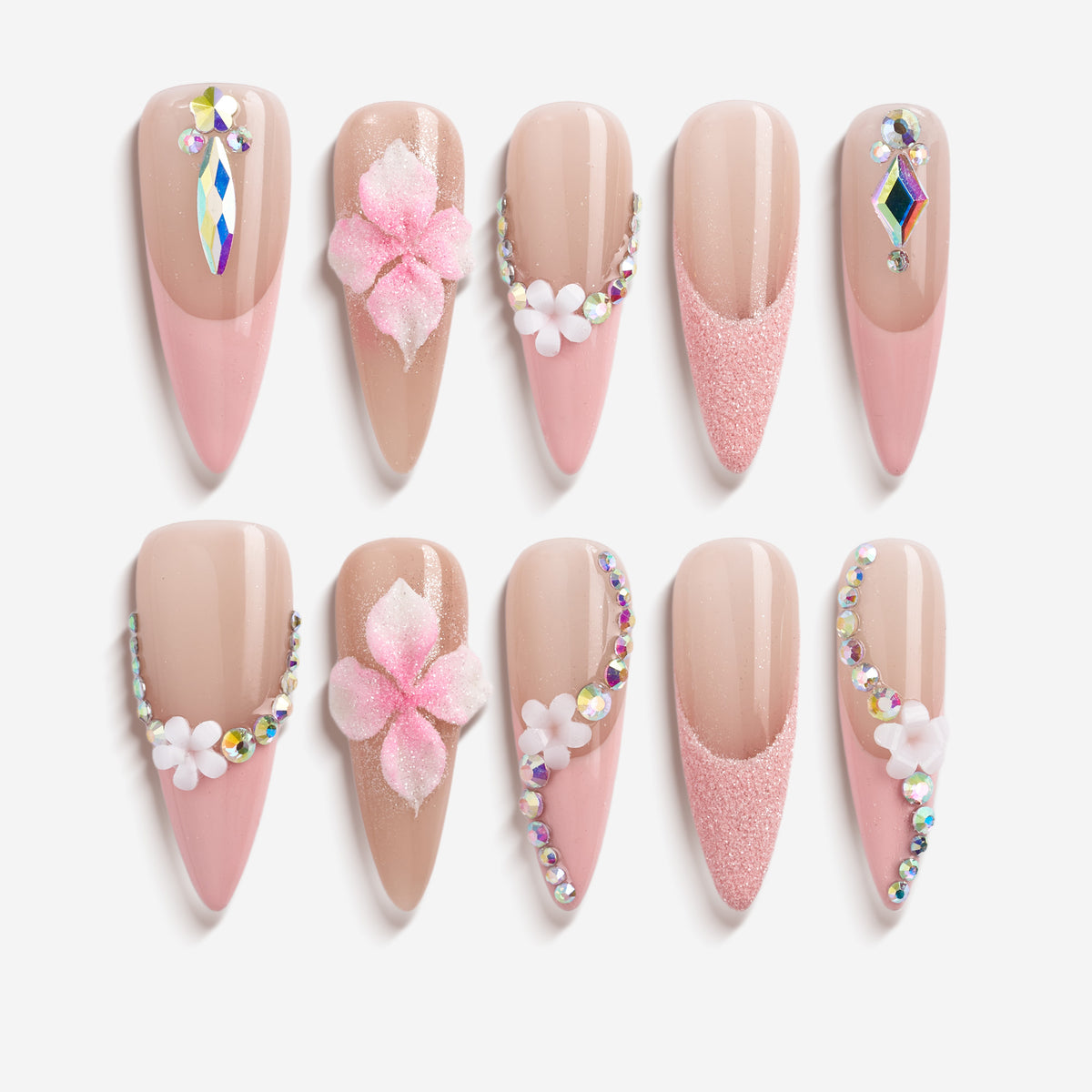 Nude press on nails with silver rhinestone arcs and floral accents. Elegant sparkle and reusable.