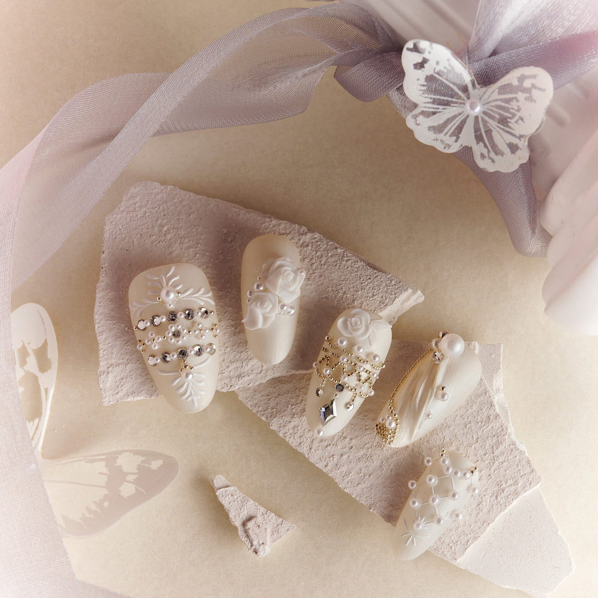 Luxury ivory wedding press on nails with pearl and crystal embellishments by BOXNAIL. Elegant cathedral-inspired bridal manicure set.