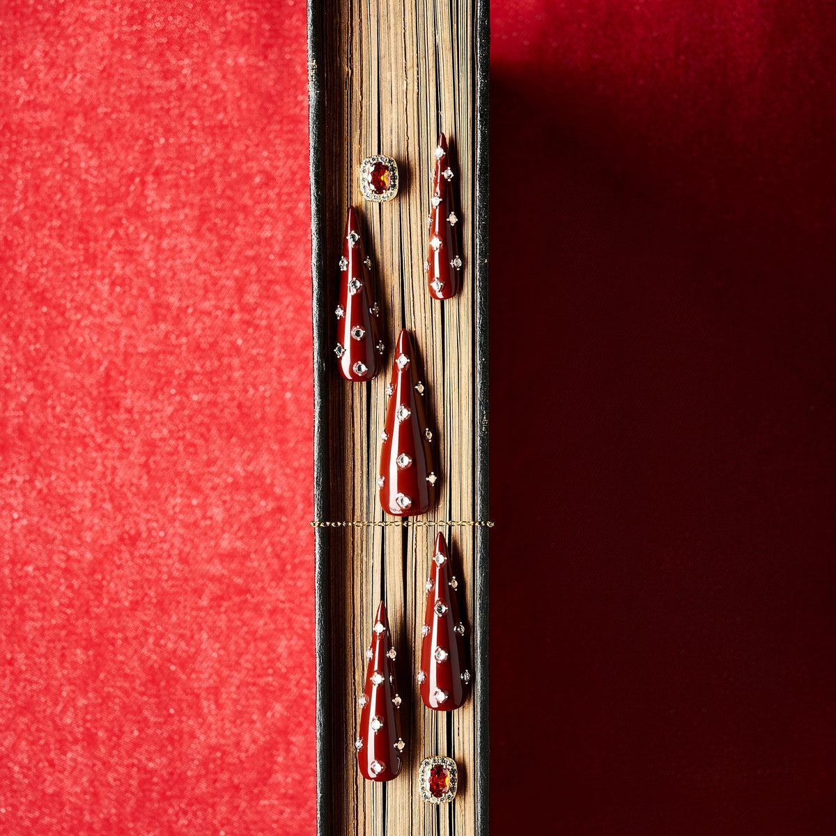 Deep burgundy long press on nails with crystal accents. Elegant reusable statement nail set.