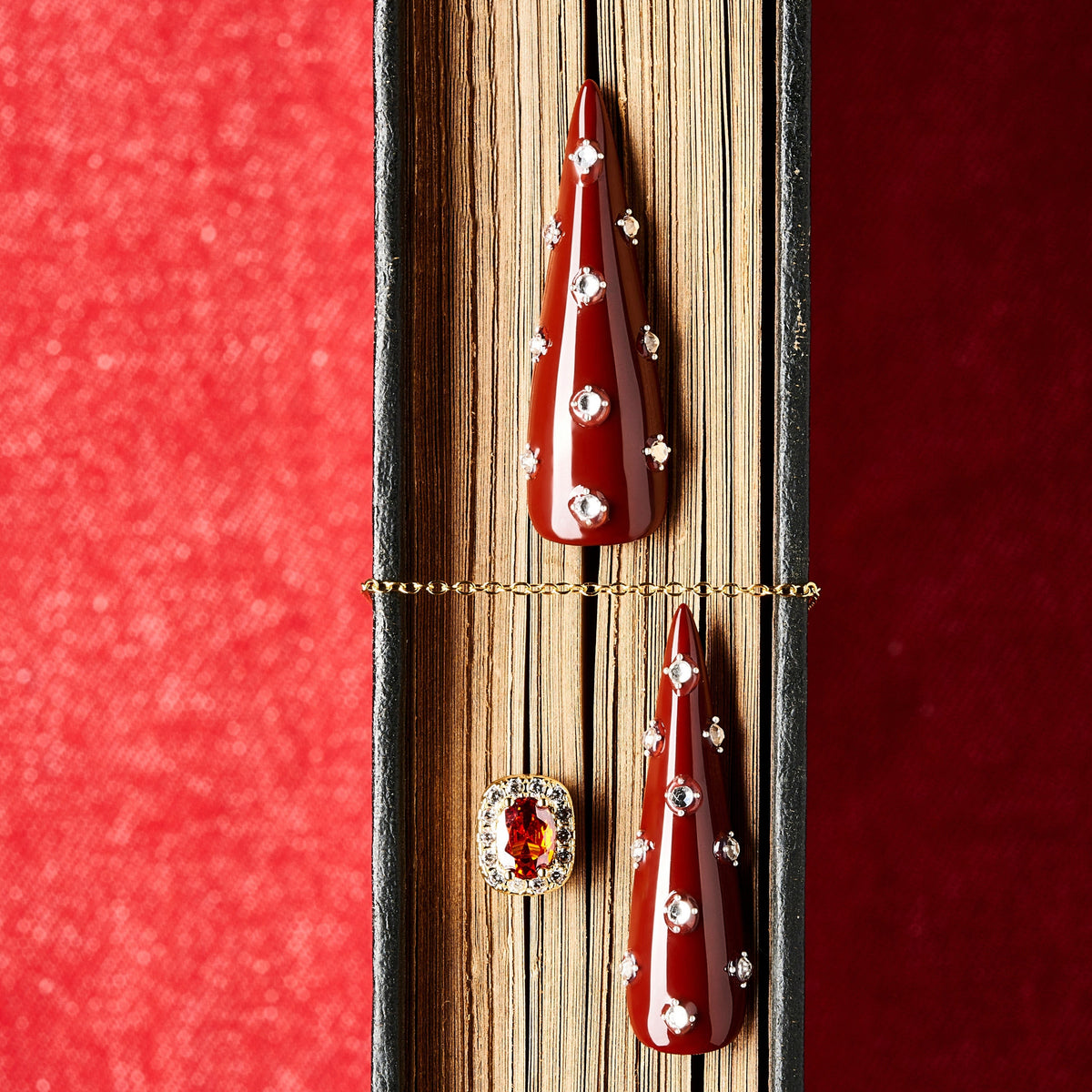 Deep burgundy long press on nails with crystal accents. Elegant reusable statement nail set.