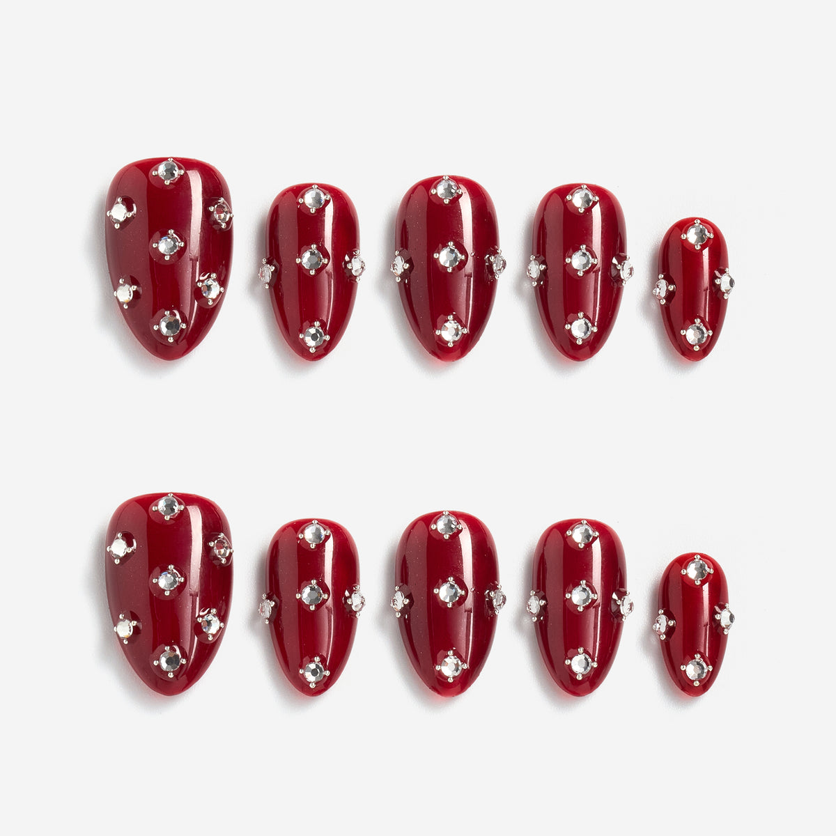 Short burgundy press on nails with crystal detailing. Reusable elegant nail art set.