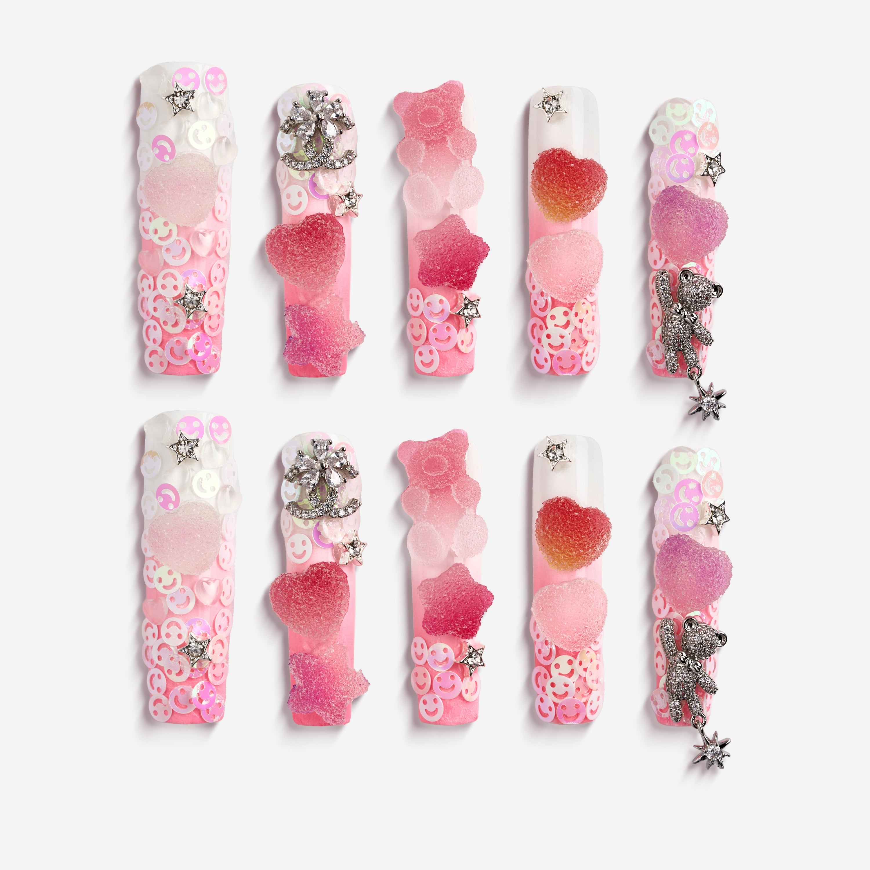 Playful 3D gummy bear press on nails with sugar heart accents and charms. Y2K inspired and reusable.