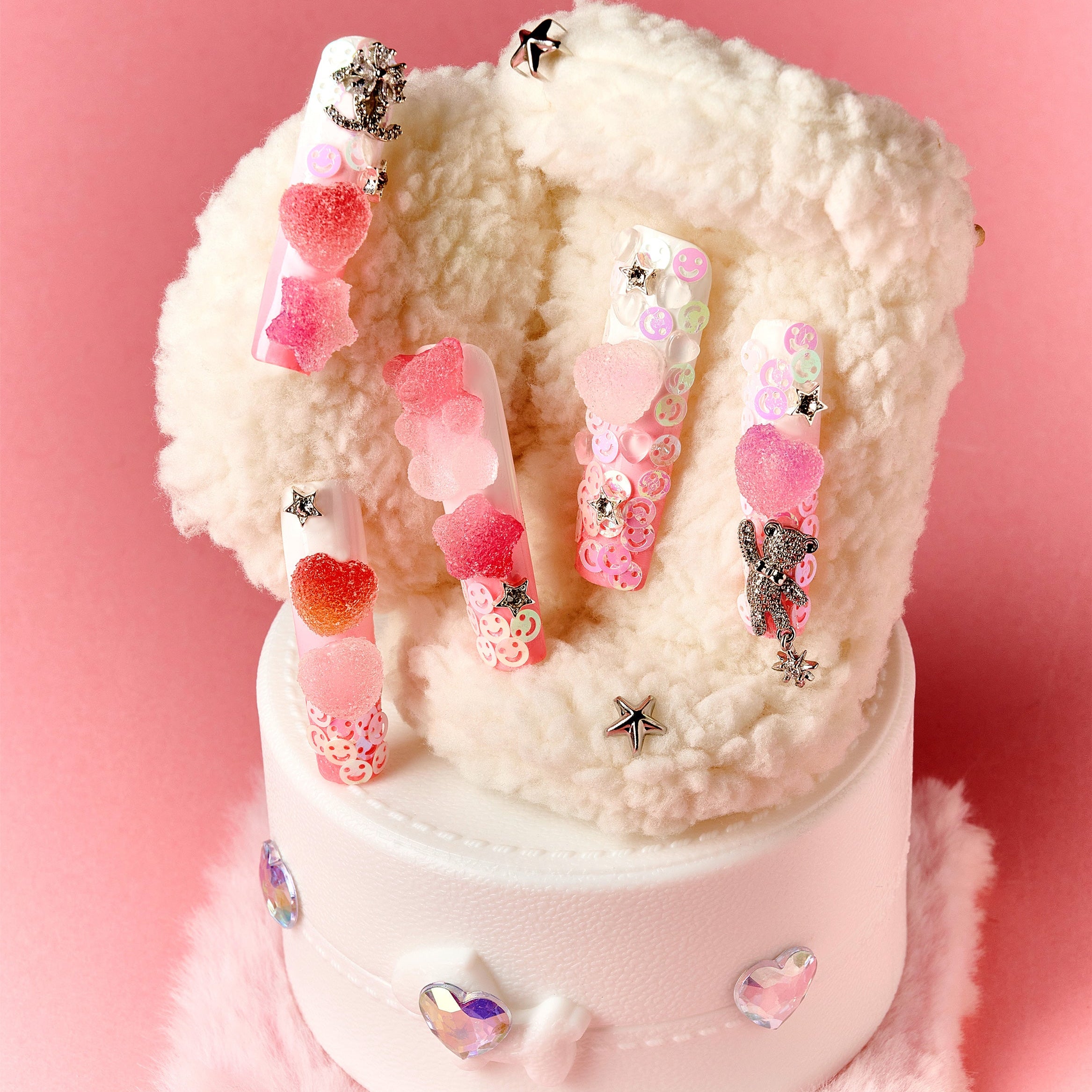 Playful 3D gummy bear press on nails with sugar heart accents and charms. Y2K inspired and reusable.